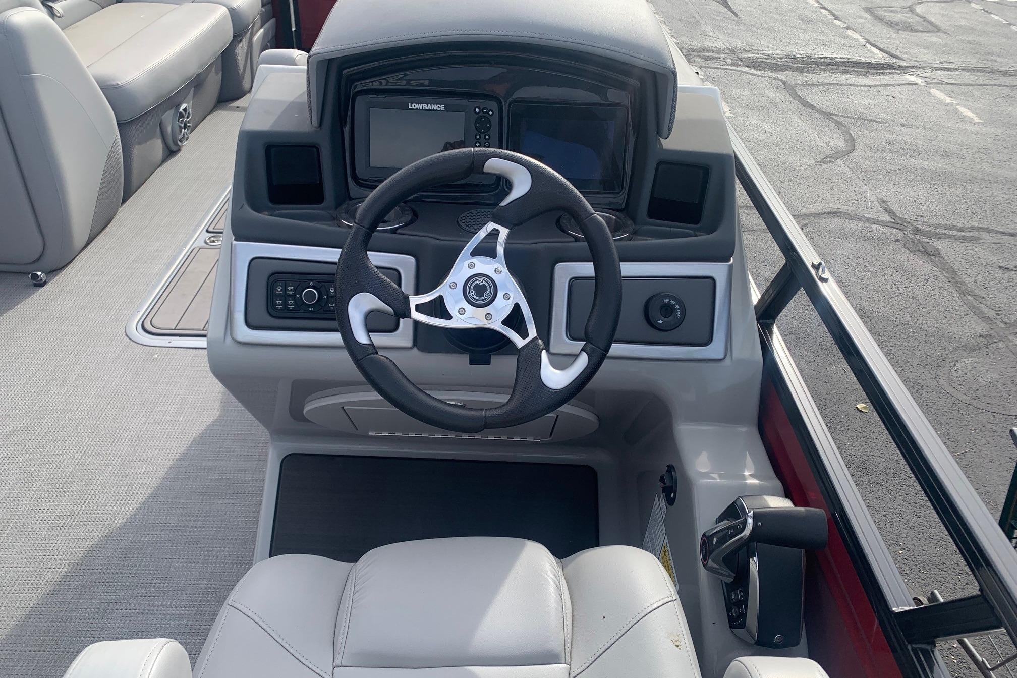 2024 Regency 250 DL3 boat dashboard with steering wheel and navigation system.