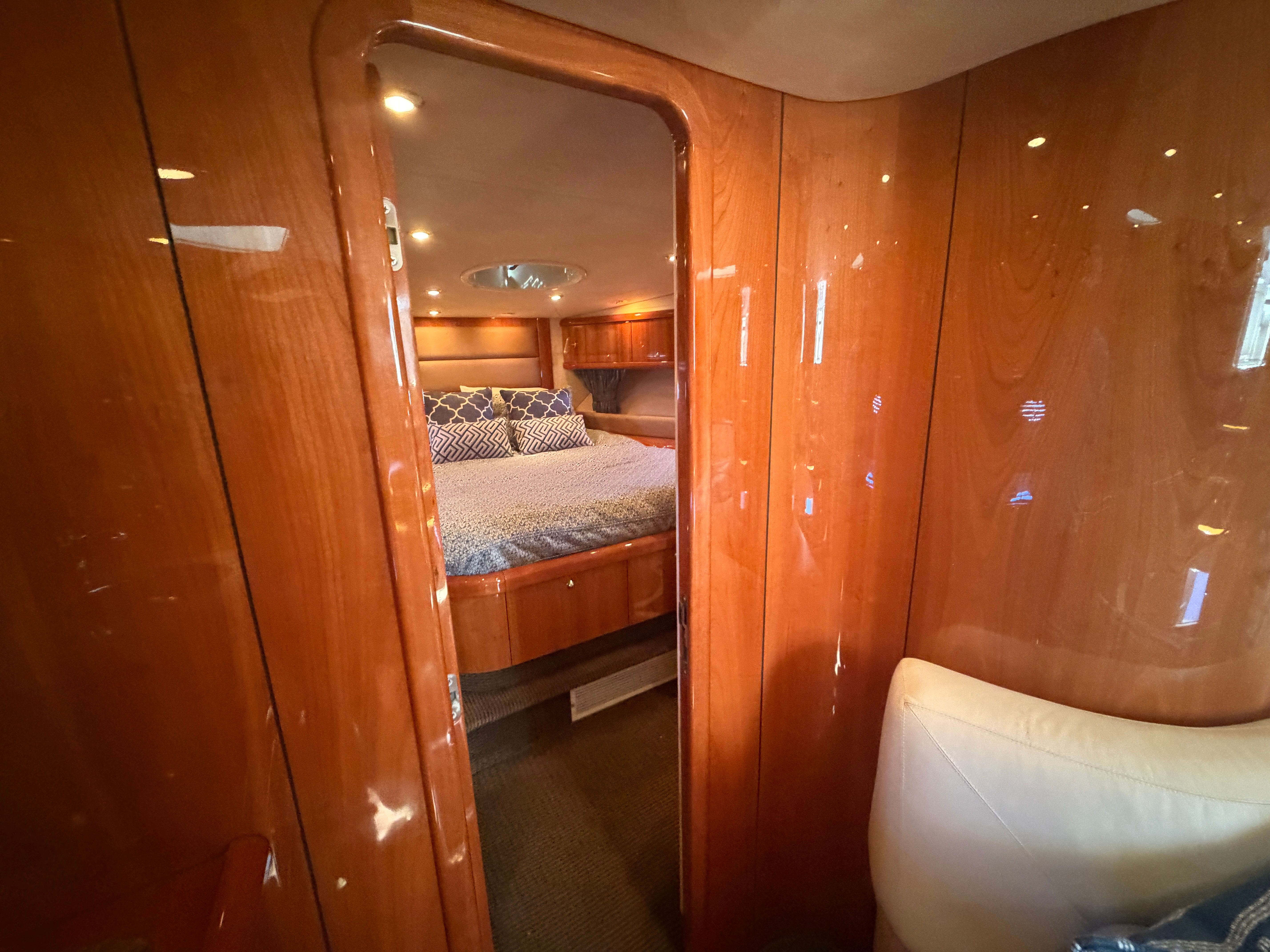 Interior of a 2008 Sunseeker Portofino 53 featuring a cozy bedroom and wooden walls.