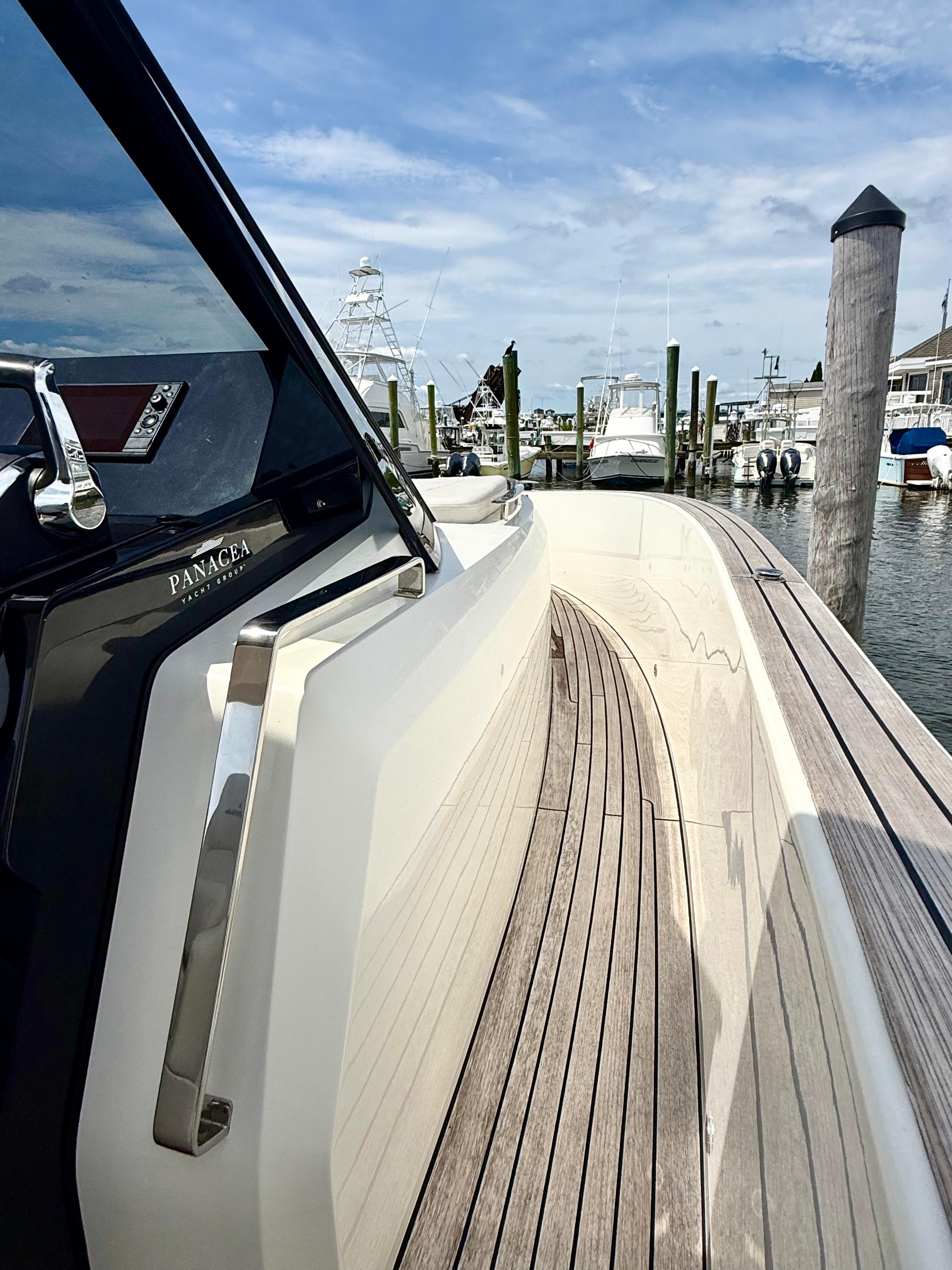 2023 Astondoa 377 Coupe Outboard docked, showcasing sleek design and wooden deck.