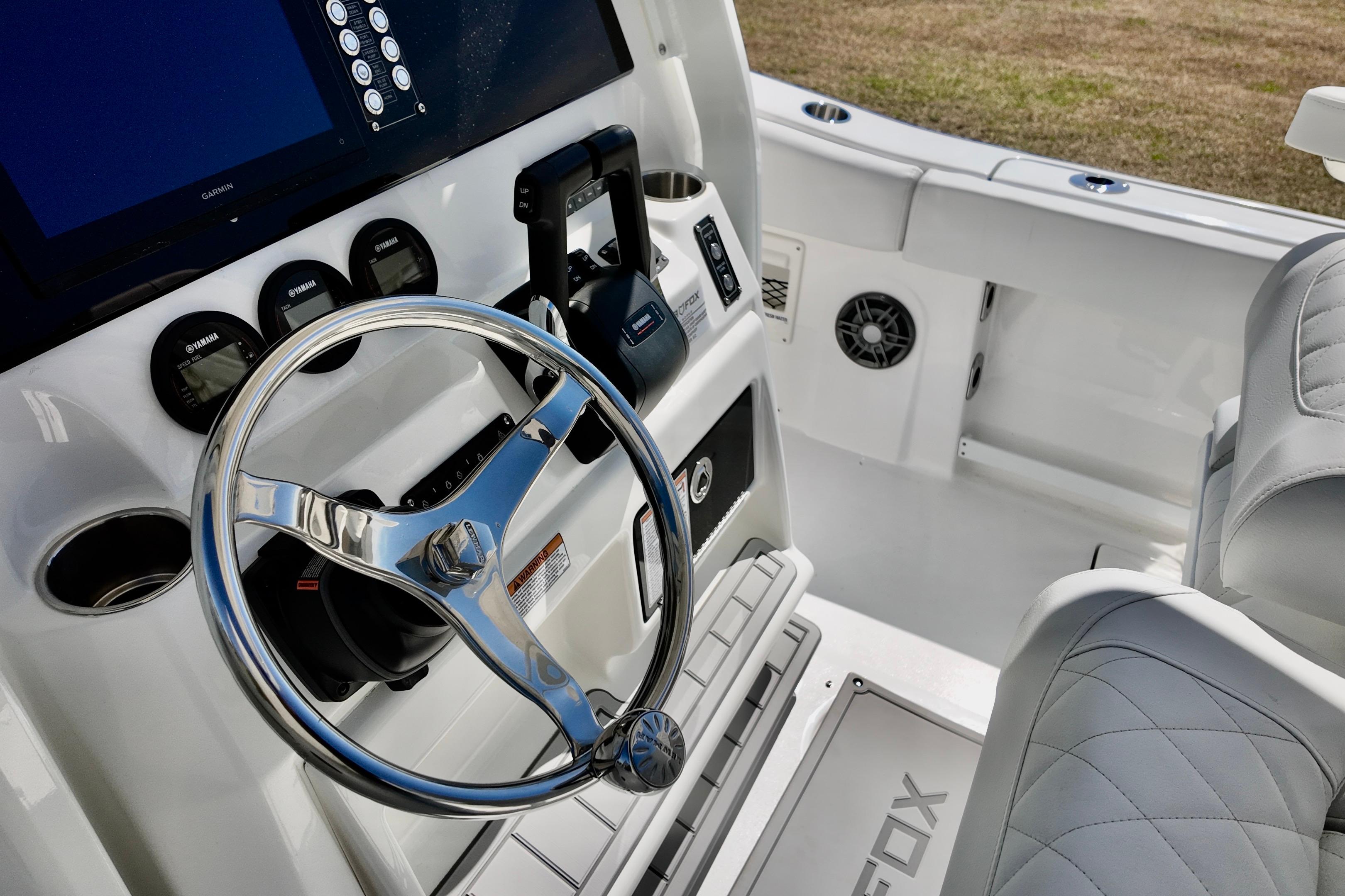 2026 Sea Fox 268 Commander boat cockpit with steering wheel and control panel.