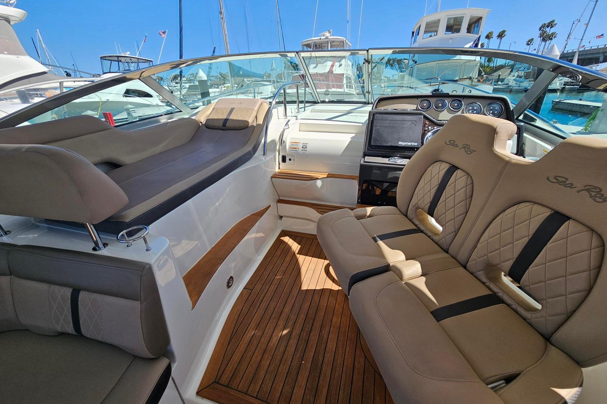 2016 Sea Ray Sundancer 350 interior with luxurious seating and modern dashboard.