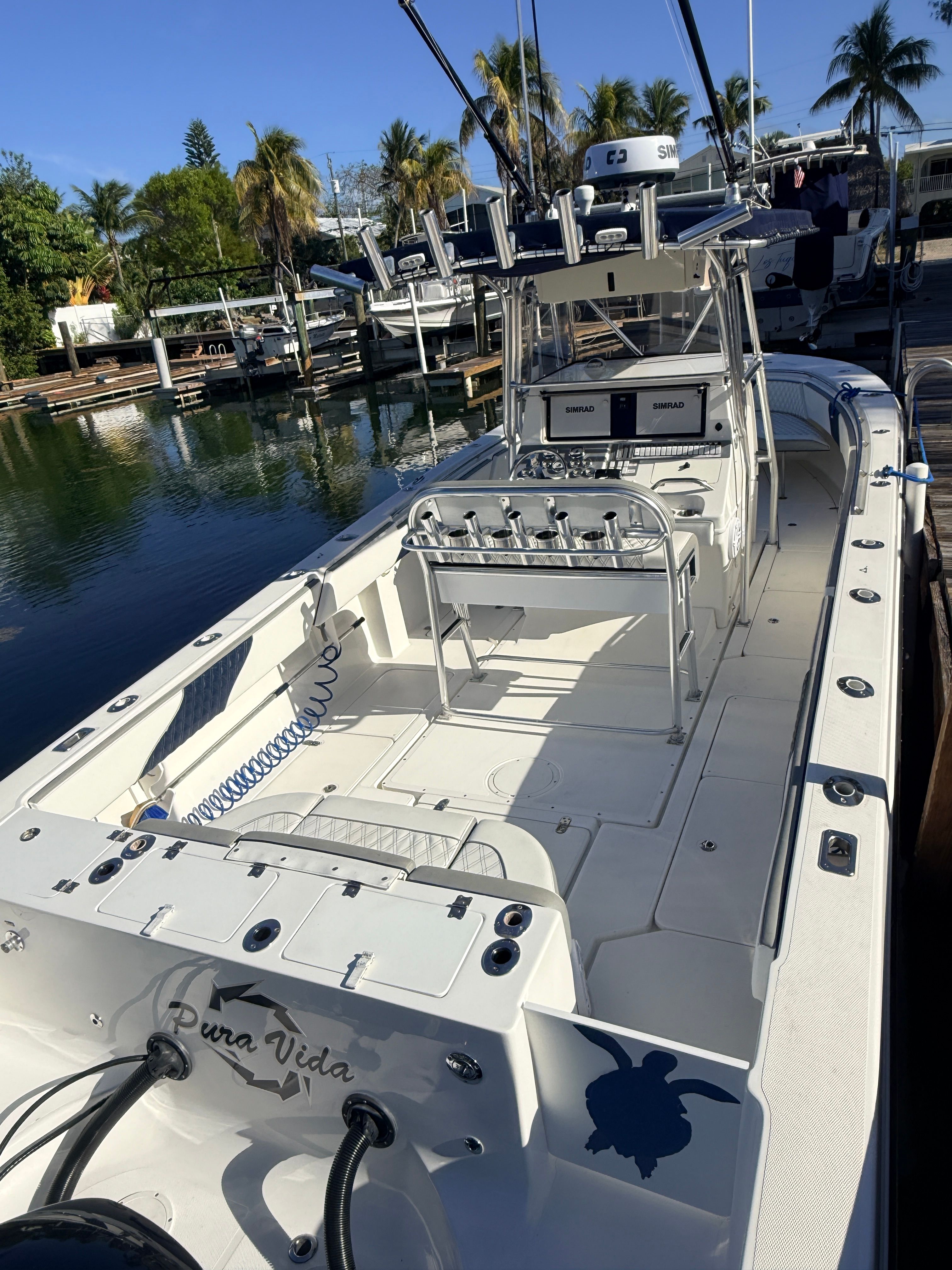 2007 Fountain 32 Center Console boat docked at marina.