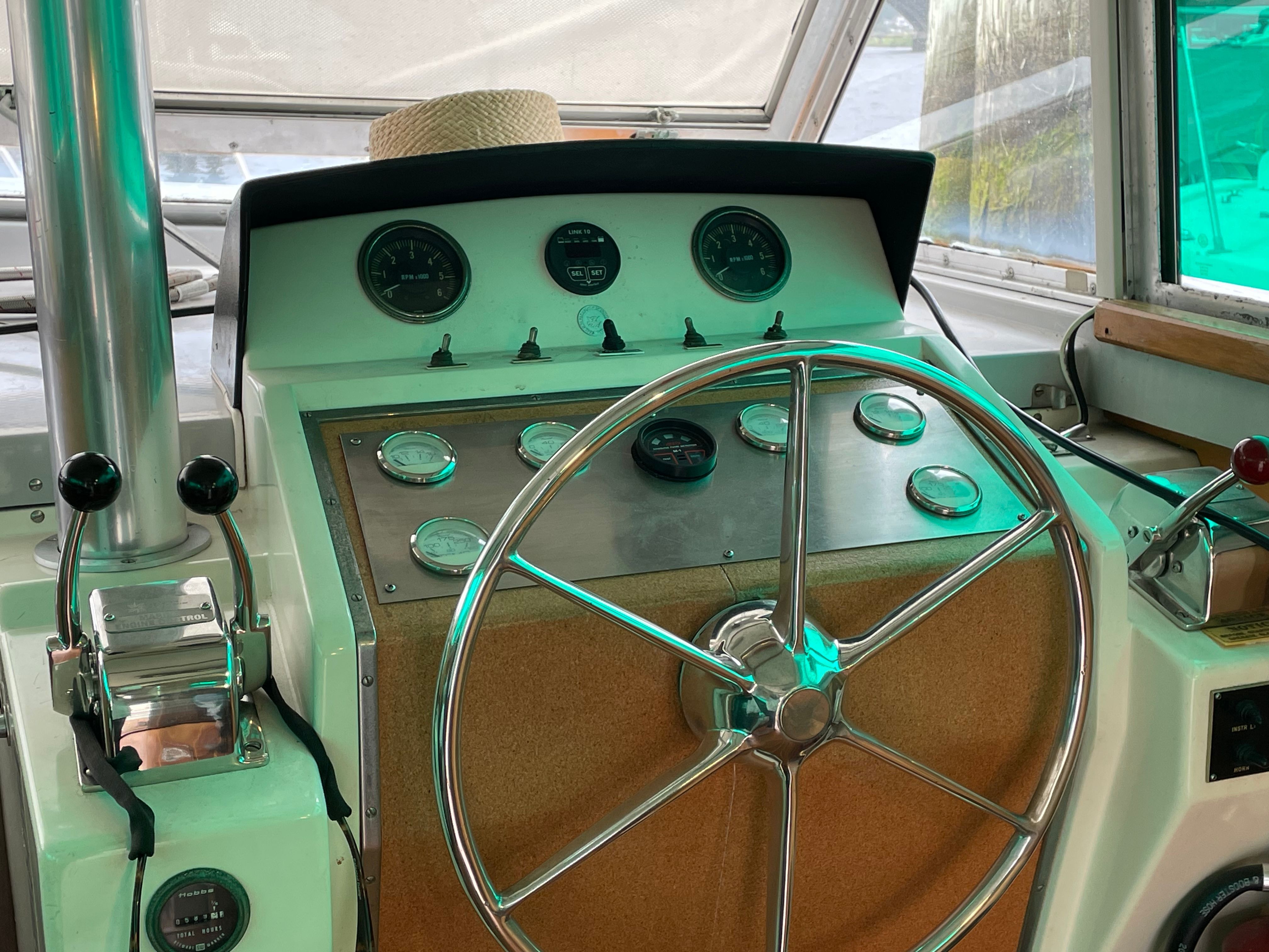 1969 Bertram Caribe boat helm with gauges and controls.