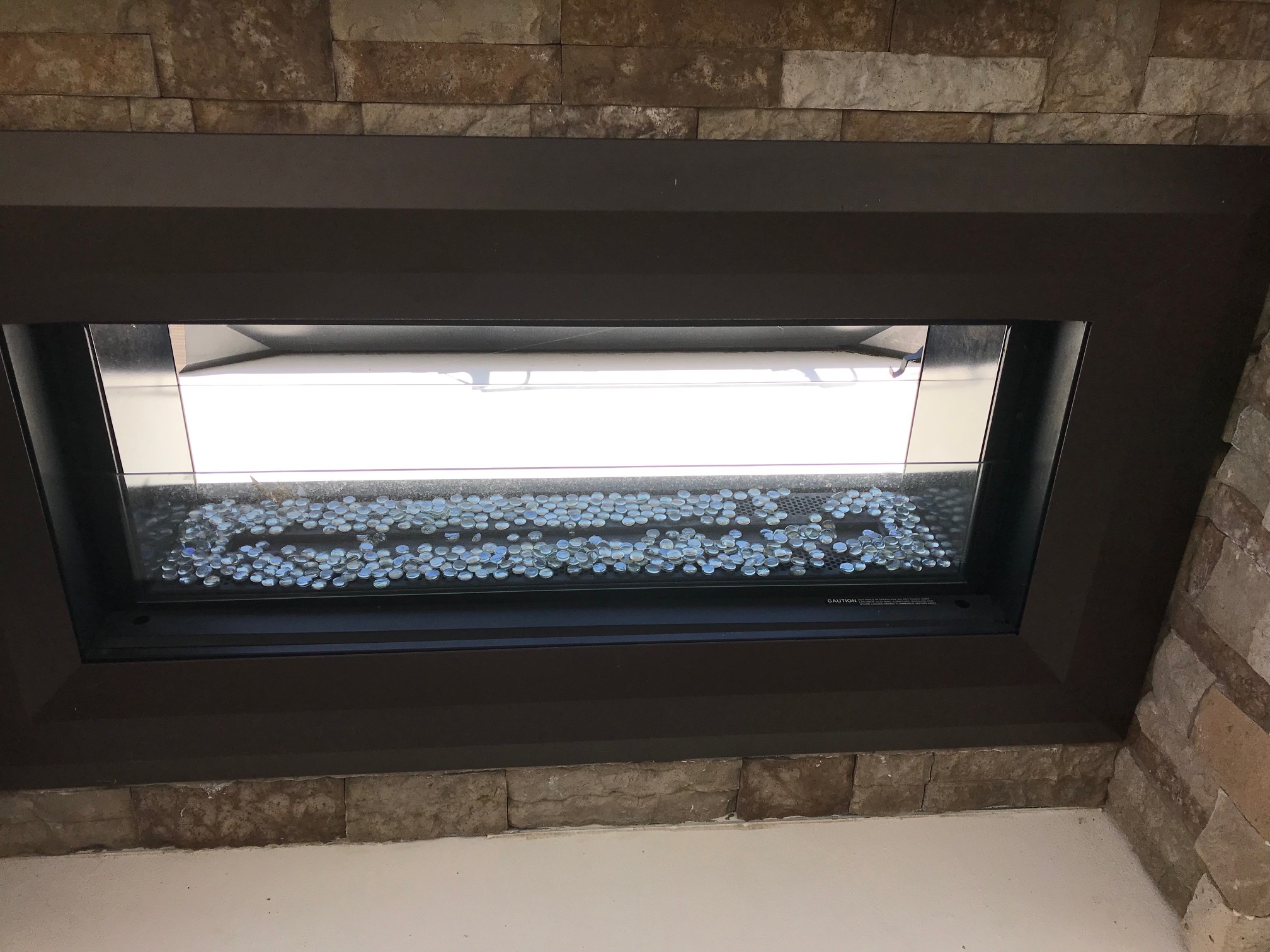 Modern fireplace with glass stones on a Sumerset 2017 houseboat.