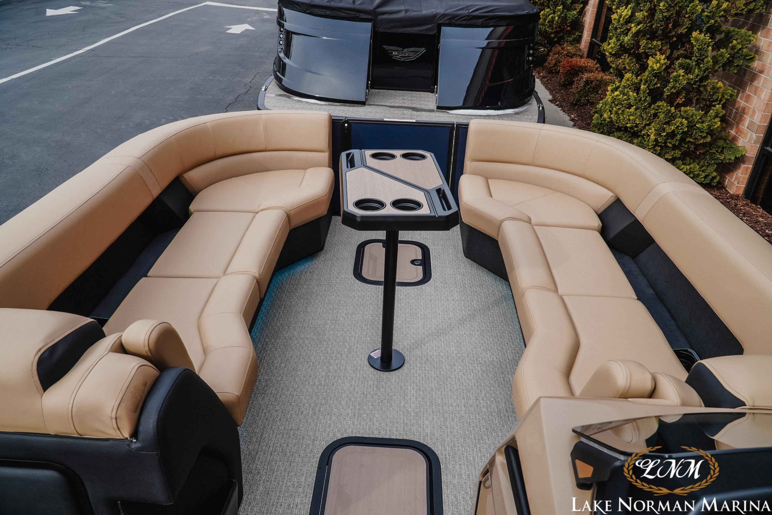Luxurious 2026 Evotti 725QL pontoon boat interior with plush seating and table.