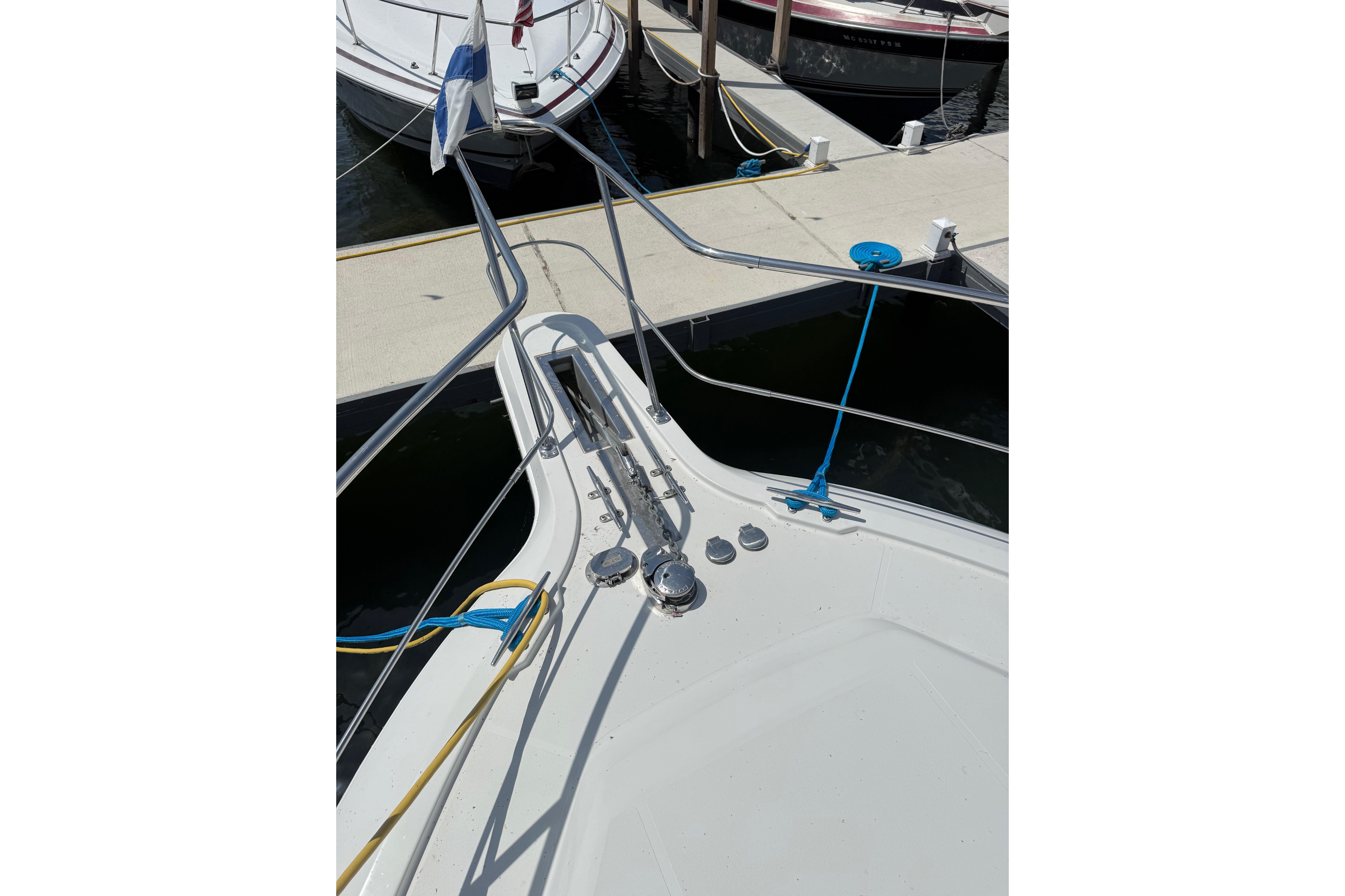 Bow view of 1996 Carver 400 Cockpit Motor Yacht docked at marina.