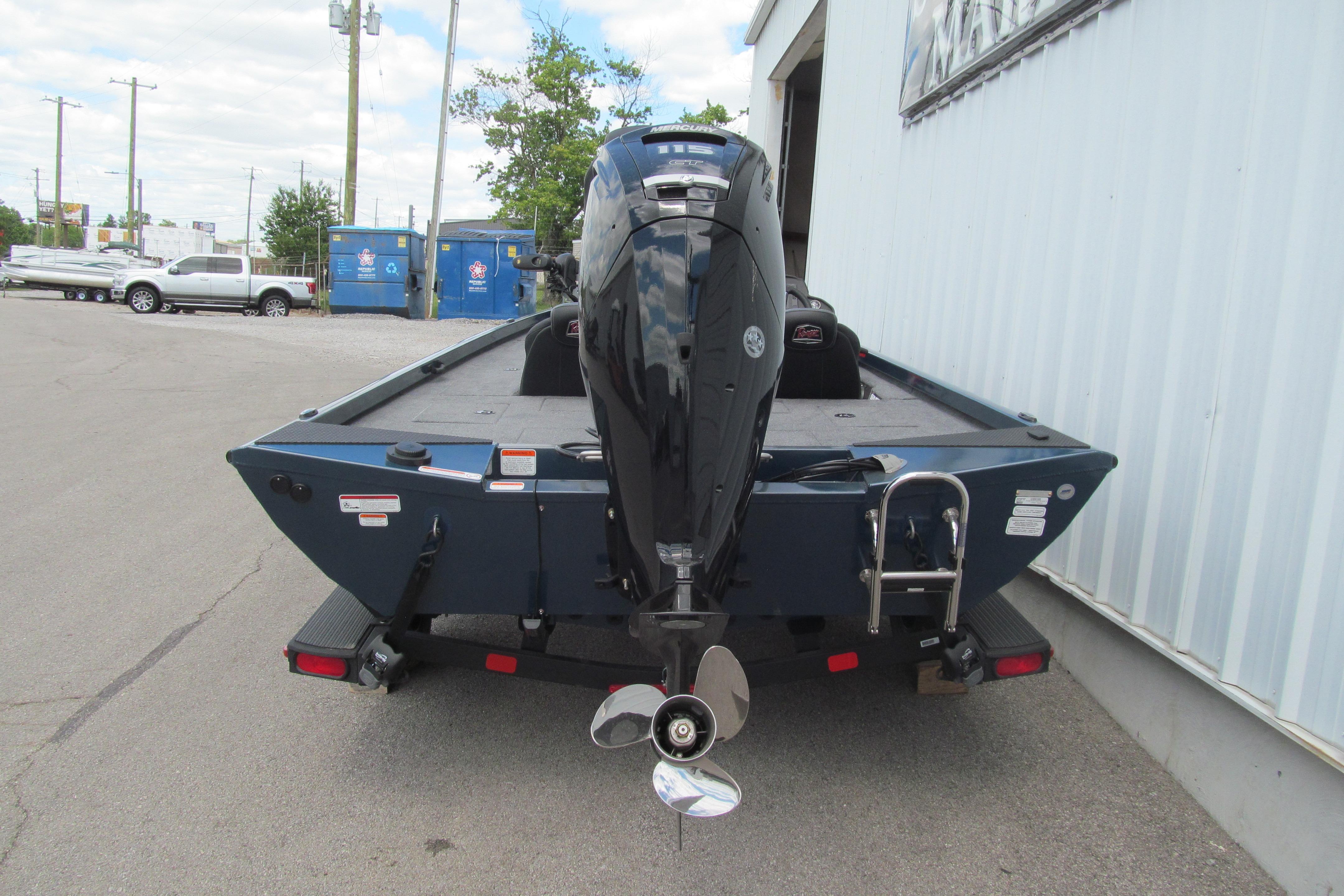 2026 Ranger RT188C boat with outboard motor, parked near a building.
