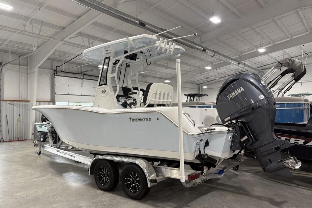 2026 Tidewater 232 CC Adventure boat with Yamaha engine in a showroom.