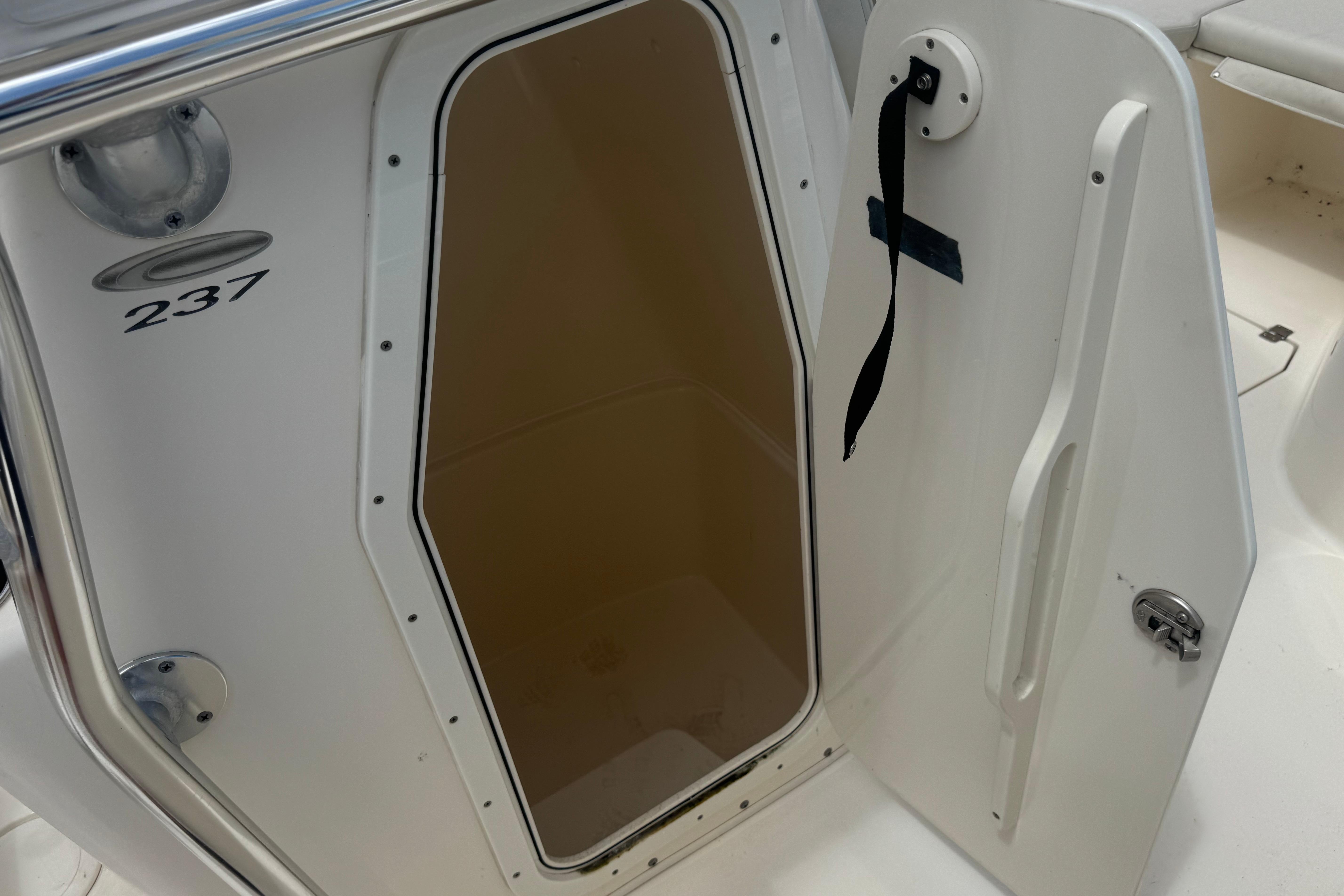 Open storage compartment on 2022 Cobia 237 Center Console boat.