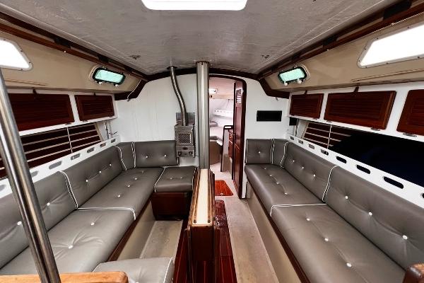 Interior of 1983 O'Day 39 sailboat with gray seating and wood accents.
