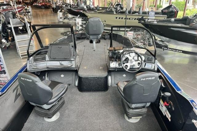 2025 Nitro ZV21 Pro boat interior with dual seats and steering console in showroom.