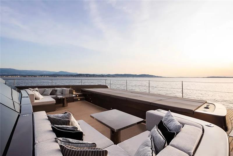 Luxurious deck of 2026 Sunreef 80 Sunreef Power yacht with ocean view at sunset.