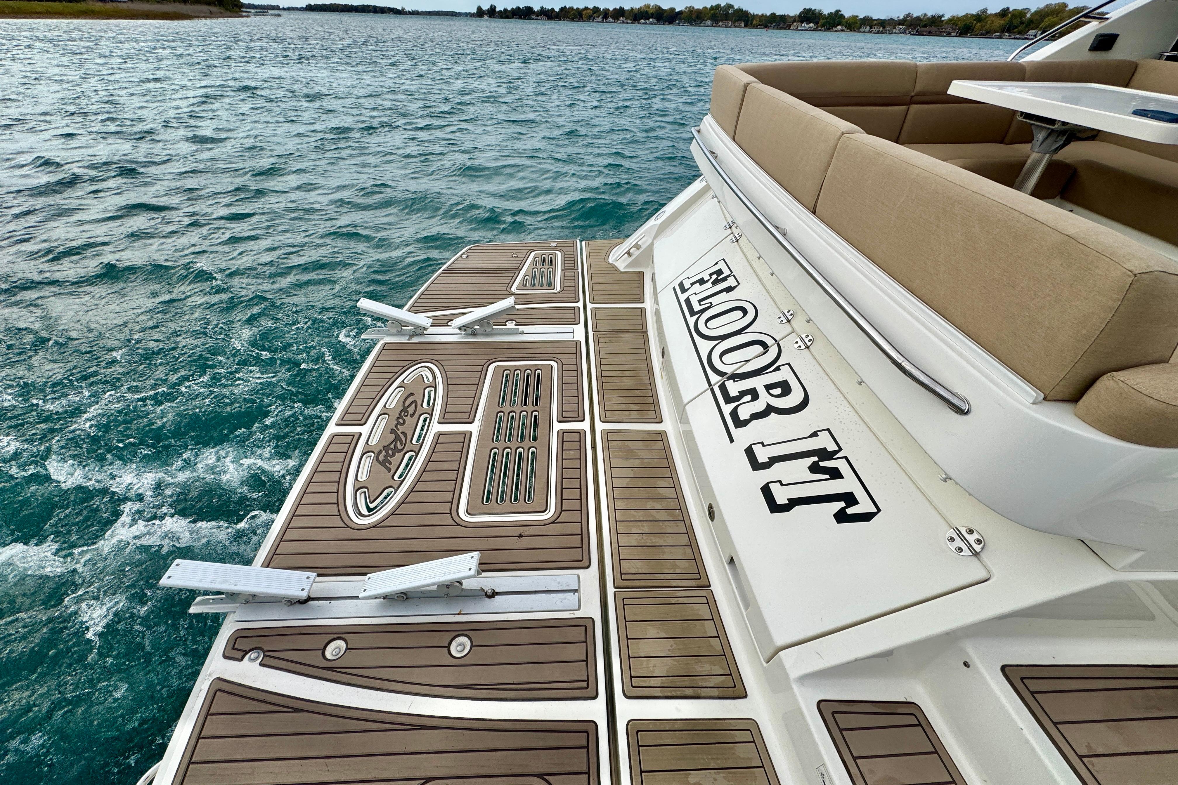 2014 Sea Ray 510 Sundancer boat with teak deck and "Floor It" text on the stern.