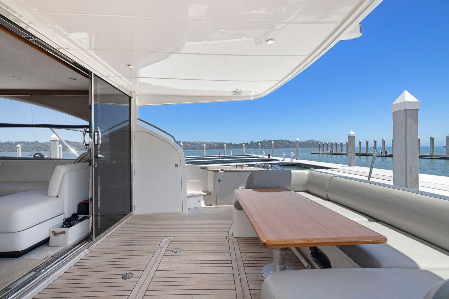 Luxurious 2015 Princess 60 Flybridge Motor Yacht with spacious deck and elegant seating area.