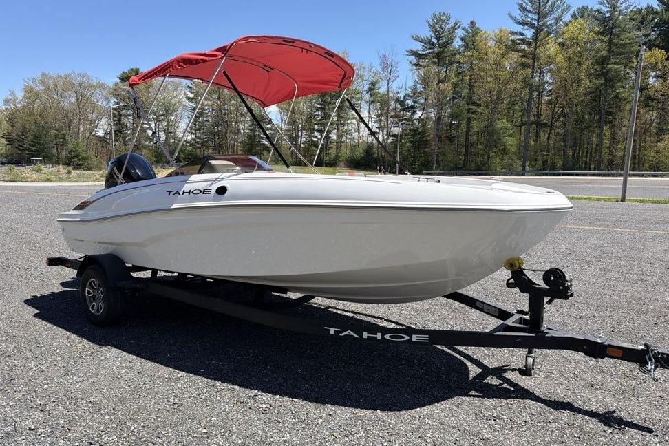 2026 Tahoe T18 boat with red canopy on trailer, parked outdoors.