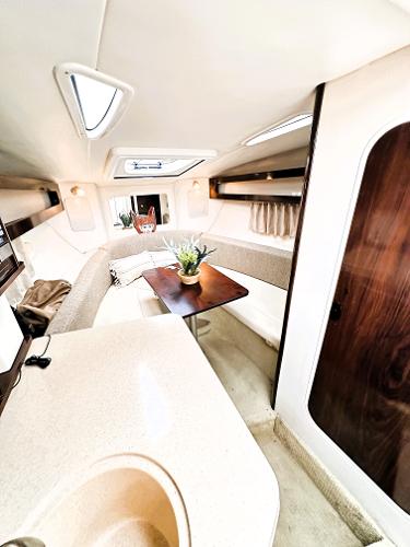 Interior of 2015 Sea Ray 260 Sundancer, featuring a cozy dining area and modern design.