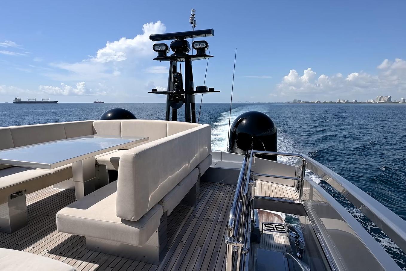 Luxurious 2015 Pershing 92 yacht cruising on open sea with elegant deck seating.