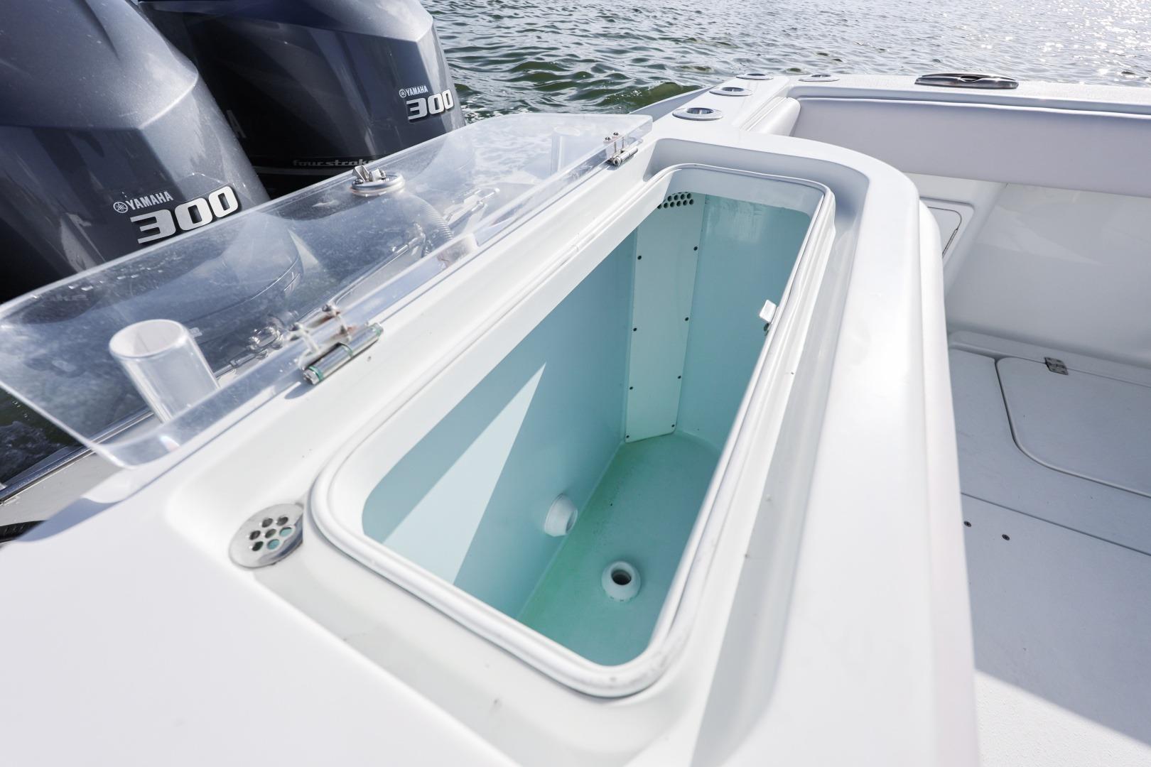 2018 Yellowfin 36 Offshore boat with Yamaha 300 engines and open storage compartment.