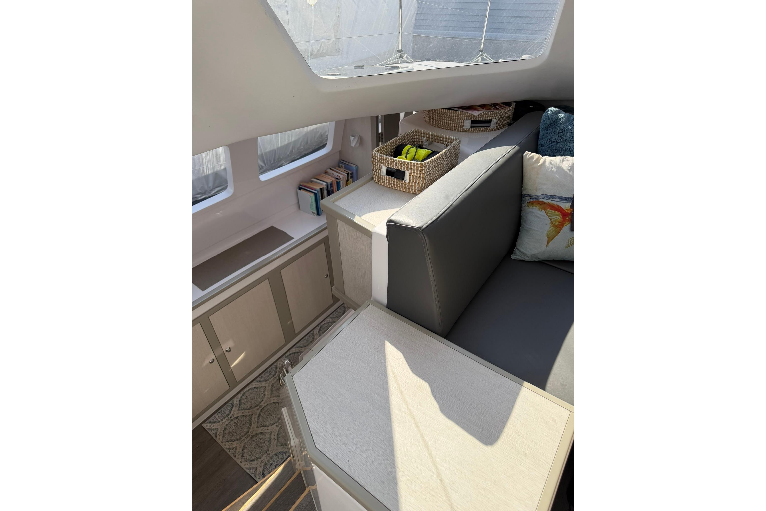 Interior of 2022 Seawind 1160 Lite catamaran with cozy seating and storage.