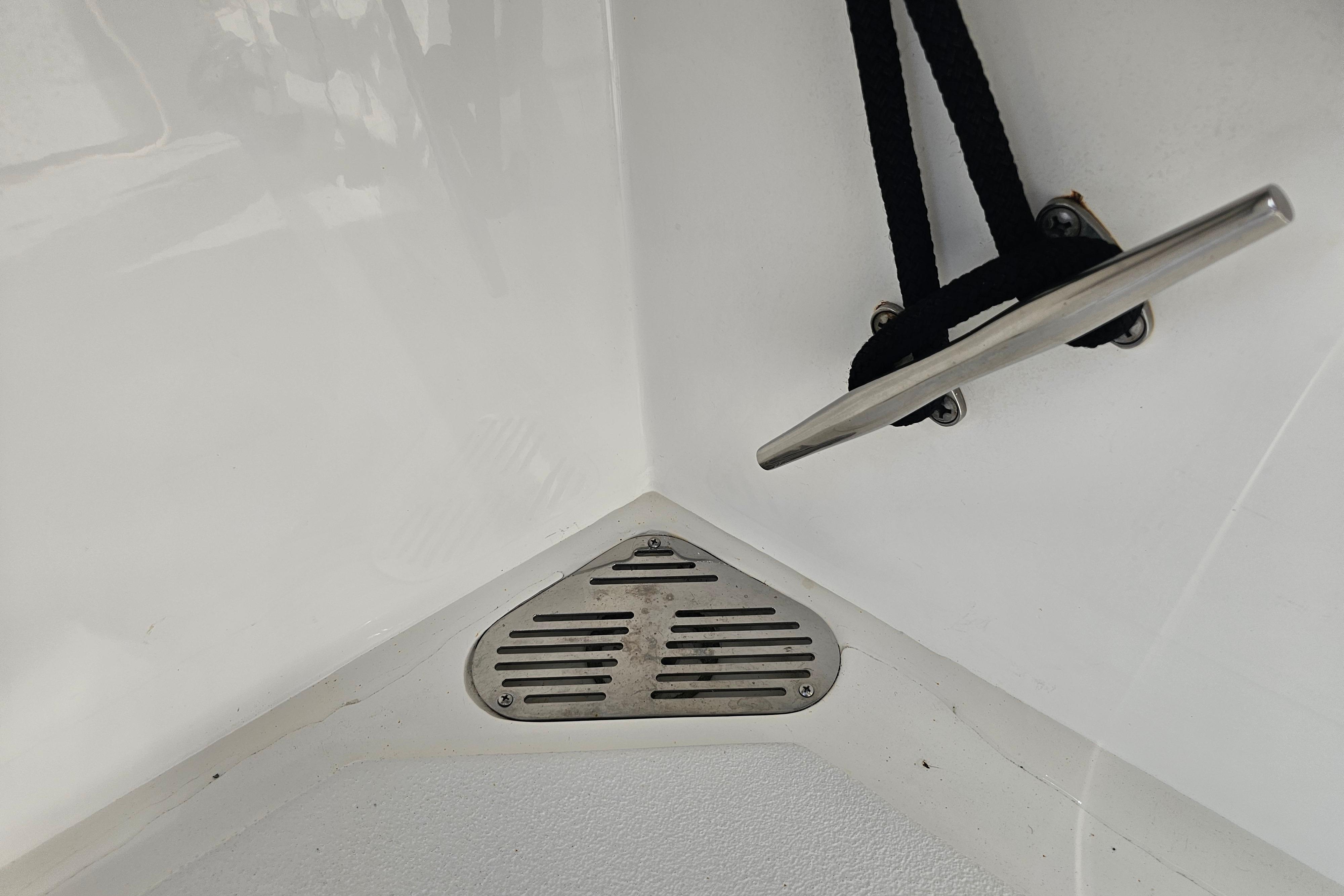 Boat deck detail with cleat and drain on 2003 Topaz 32 Express.