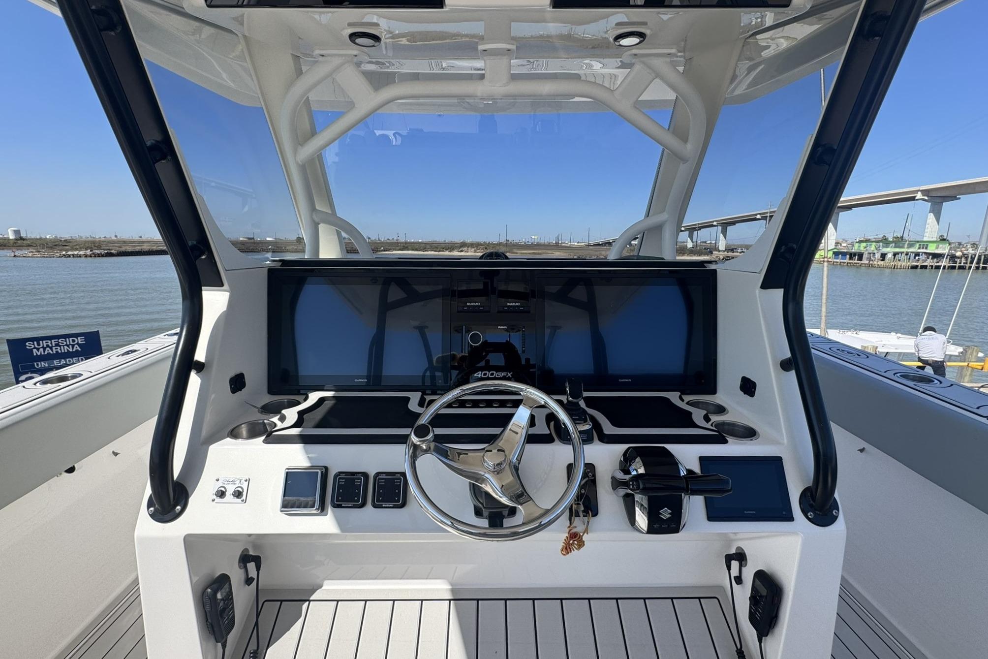 2023 Twin Vee 400 GFX CC boat dashboard with steering wheel and digital displays.
