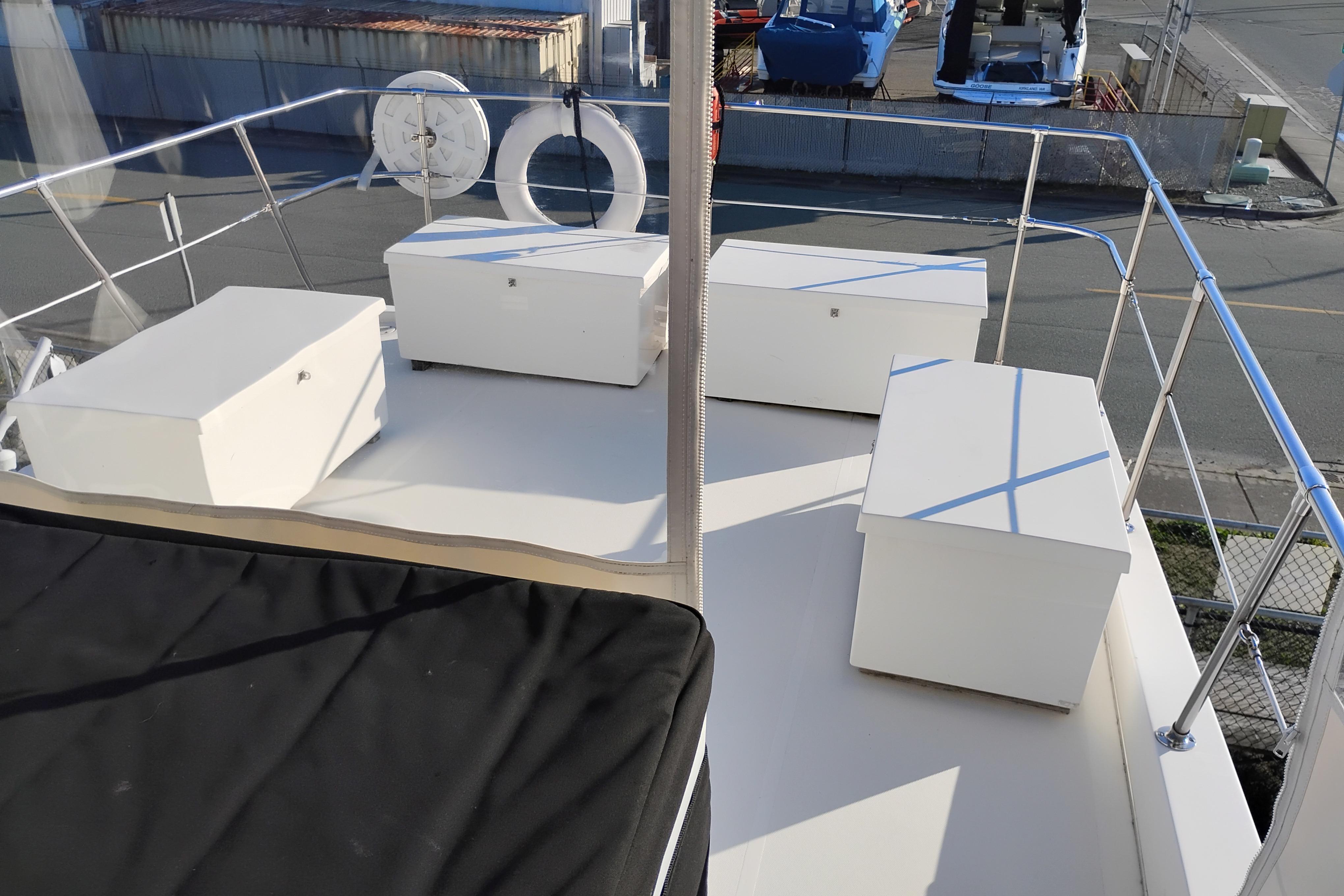 2002 Canoe Cove 50 Pilothouse Motor Yacht deck with storage boxes and life ring.