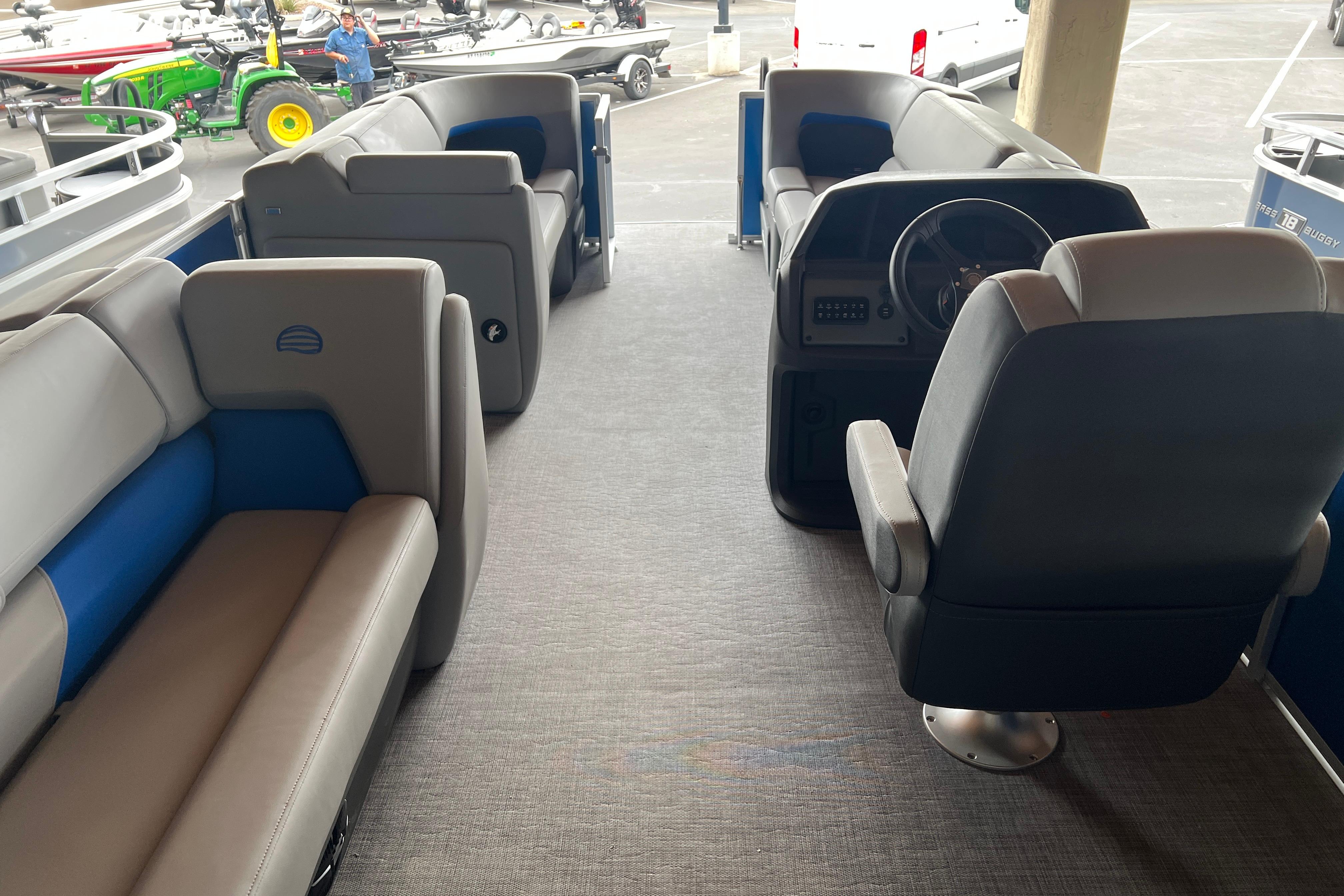 2026 Sun Tracker Party Barge 20 DLX interior with seating and steering console.