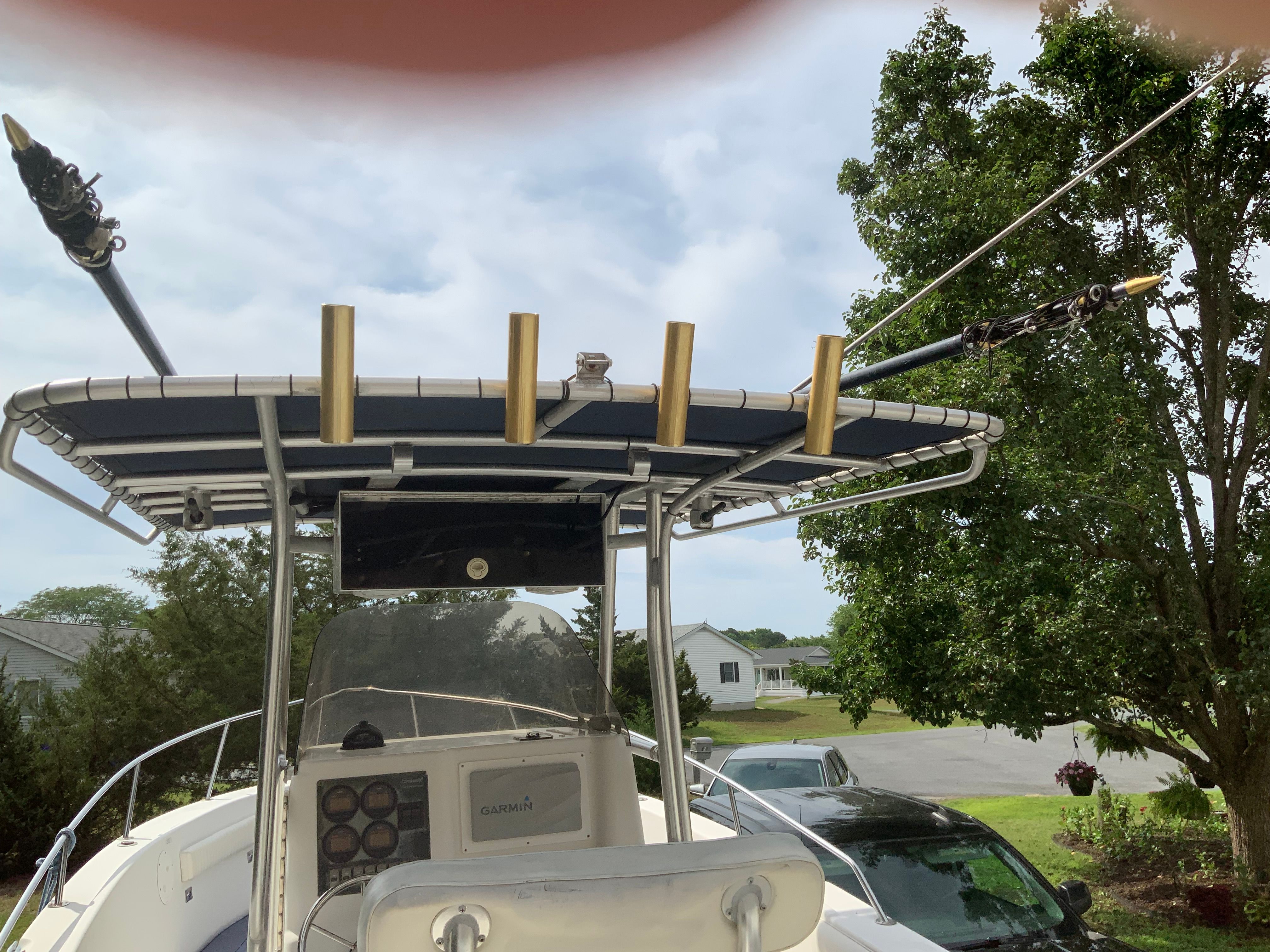 The image shows the cockpit of a 2006 Seaswirl Striper 26 with rod holders and a helm station.