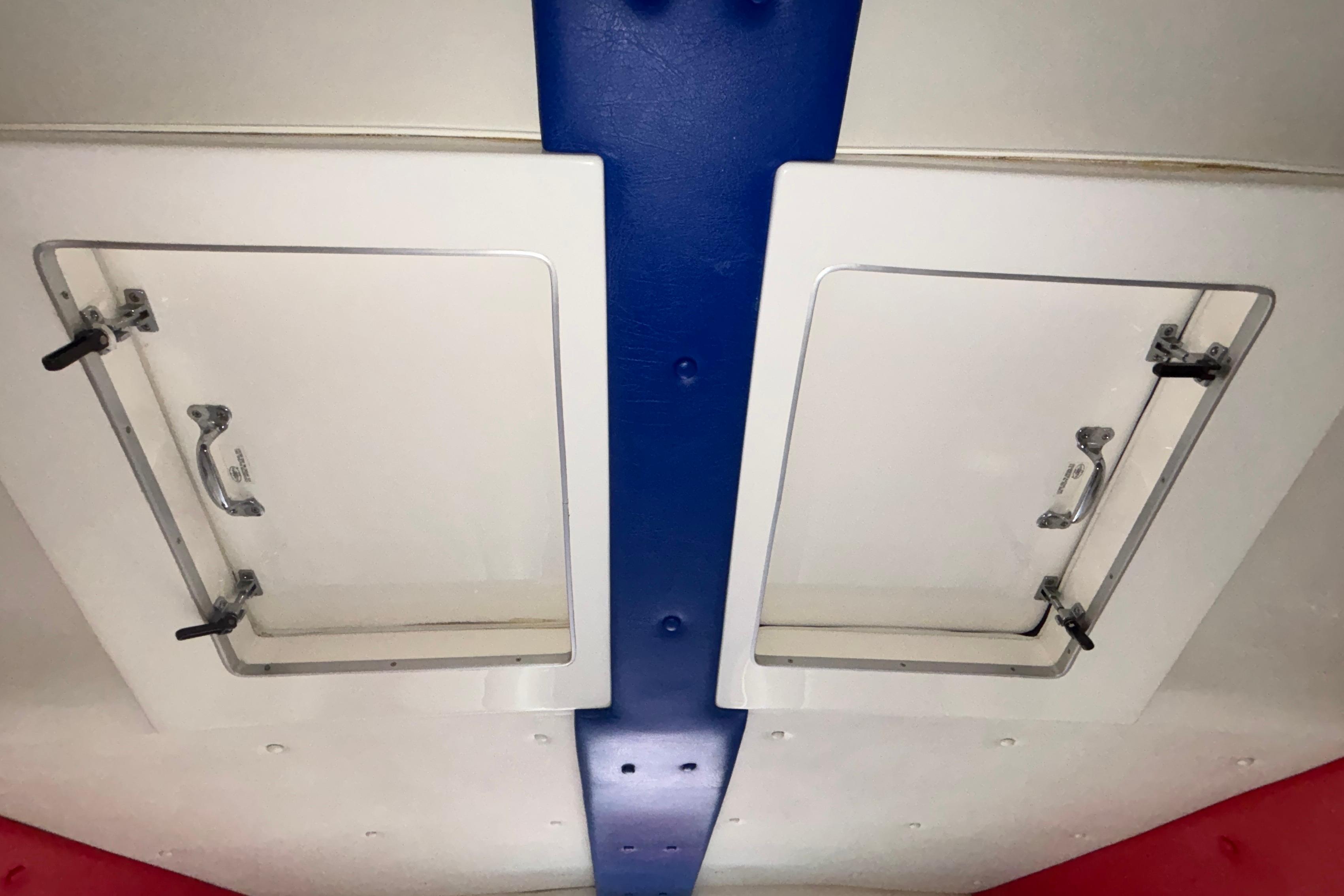 2003 Cigarette 38' Top Gun boat interior hatches with blue and red accents.