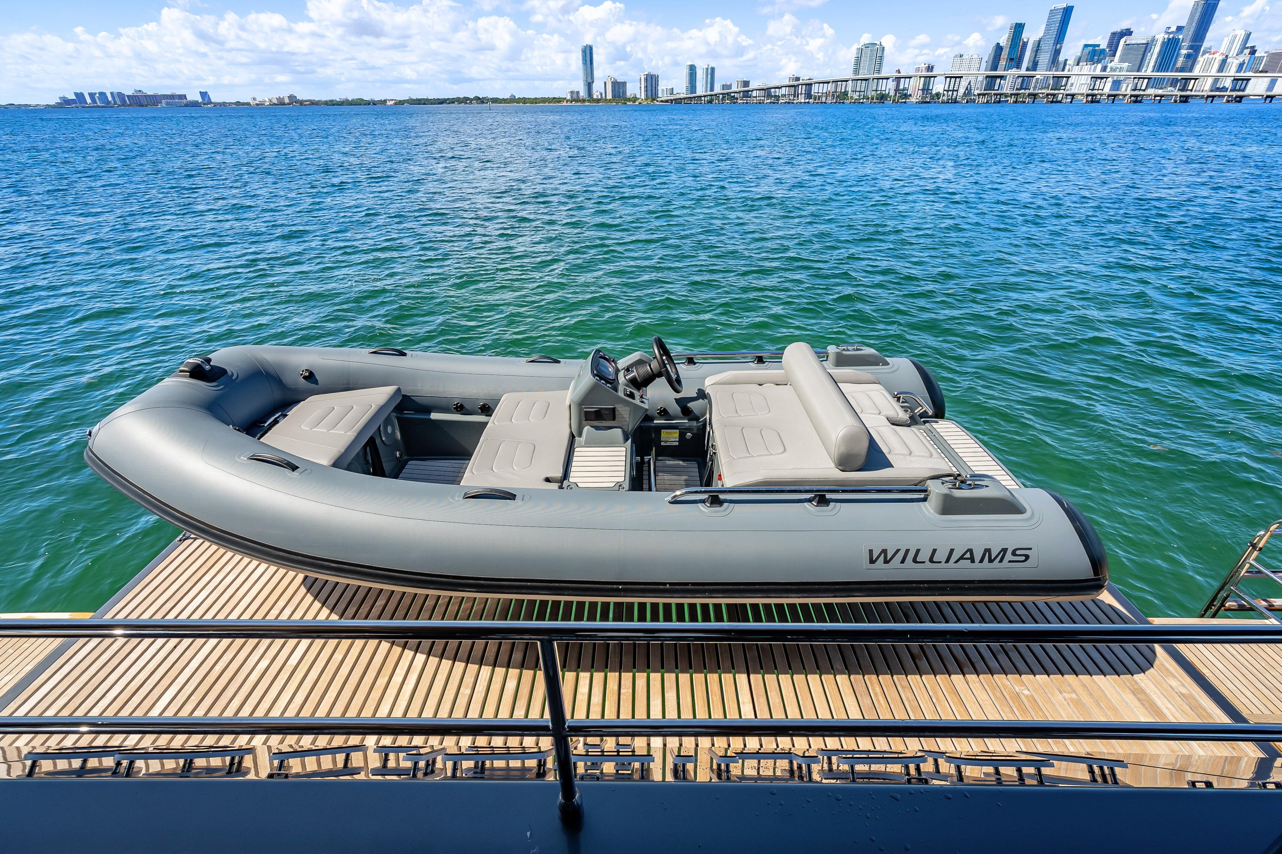 Luxury yacht Sunreef 60 Power 2026 with Williams tender on deck, overlooking city skyline.