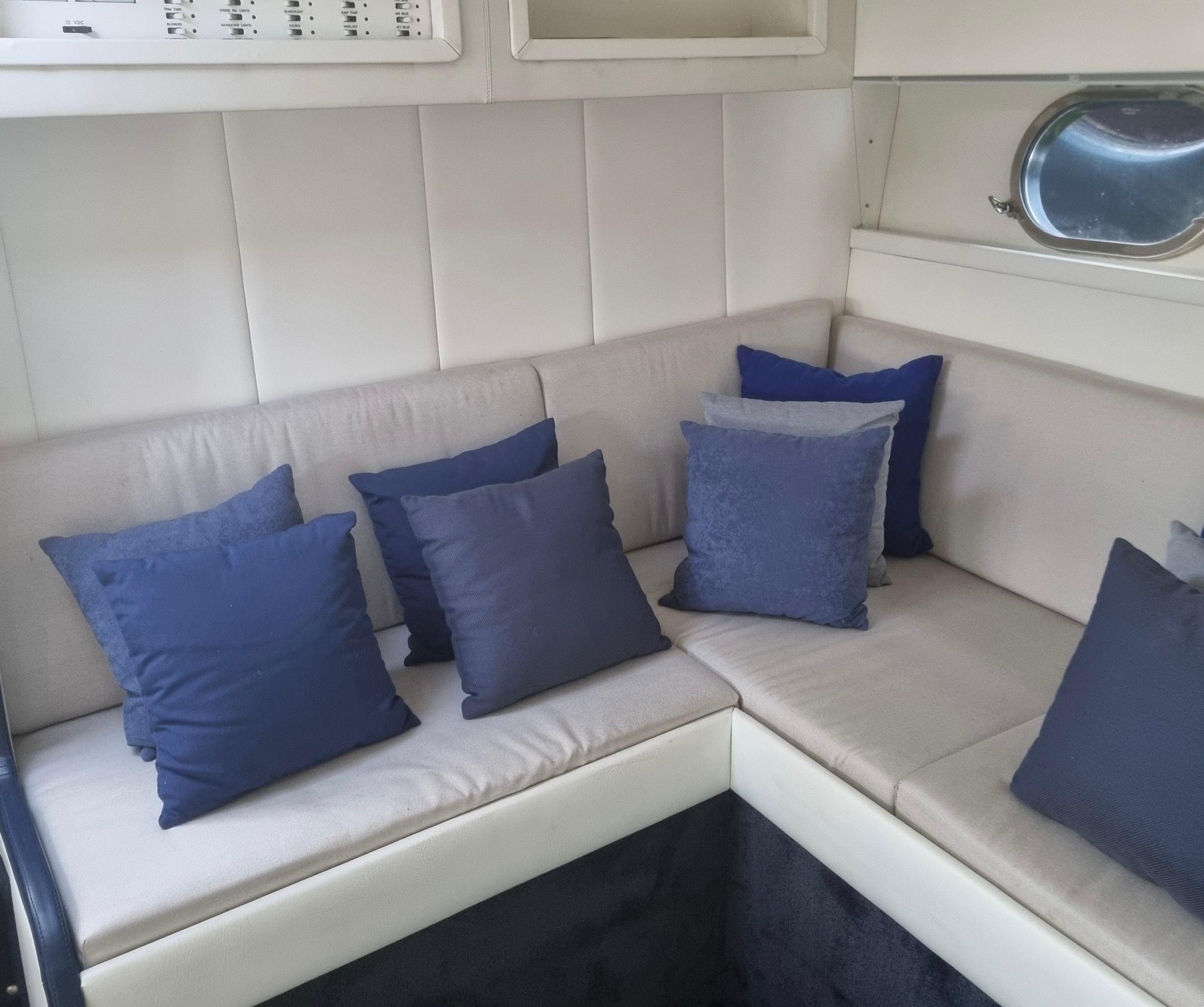 Interior of a 1990 Magnum 40 yacht with blue and gray cushions.