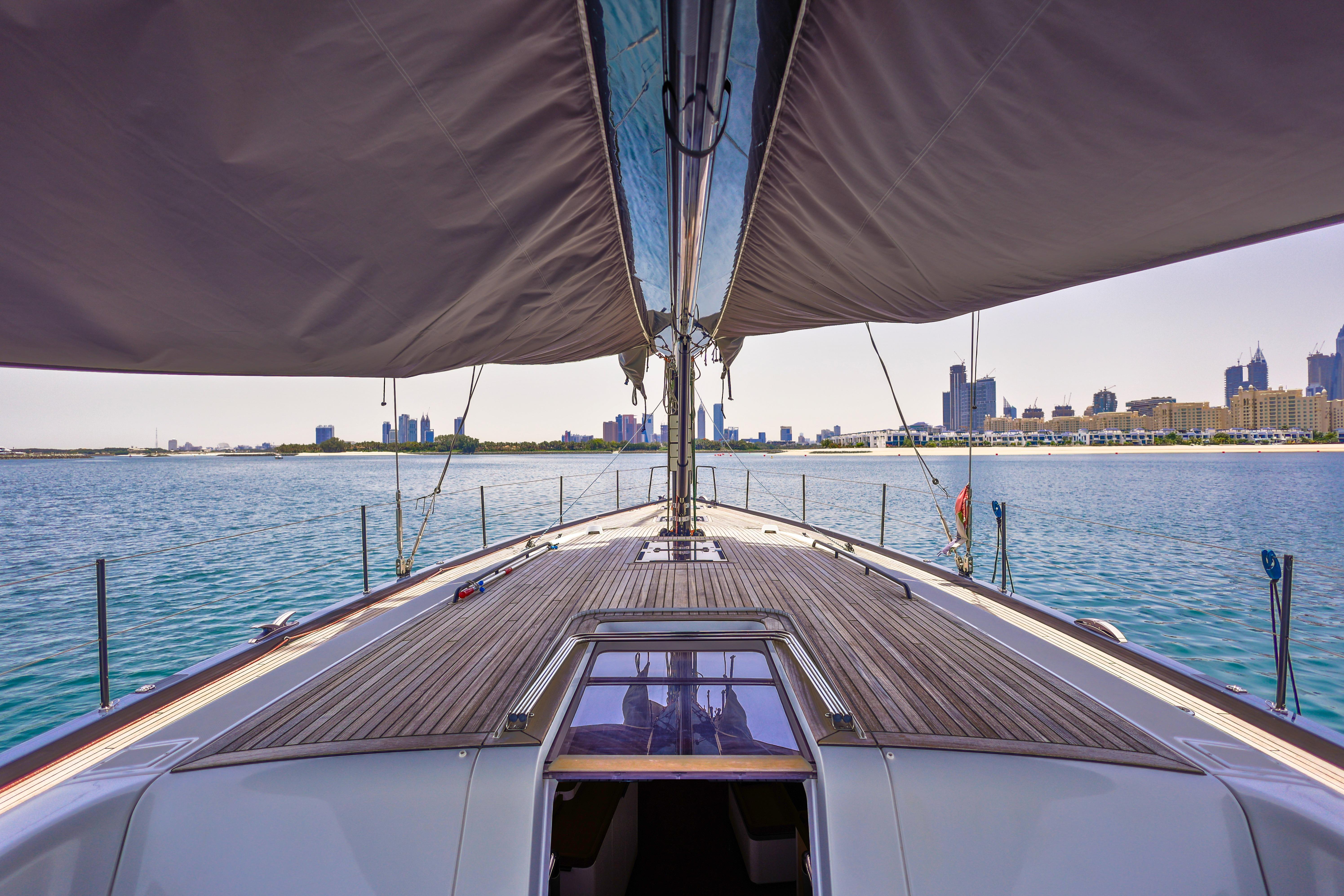 2021 Beneteau First 53 yacht sailing with city skyline in the background.