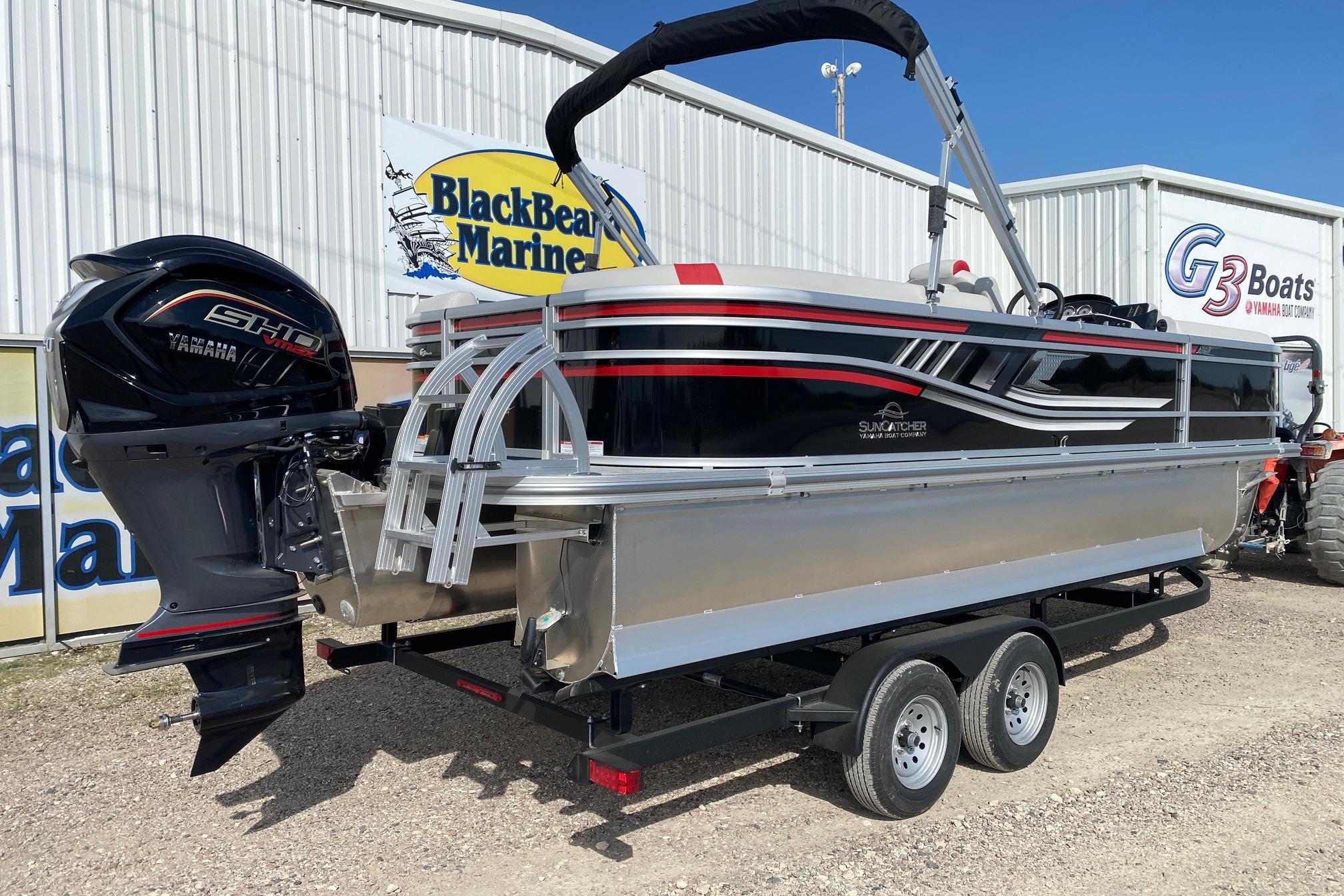 2026 SunCatcher Select 322RC pontoon boat on trailer at BlackBear Marine dealership.