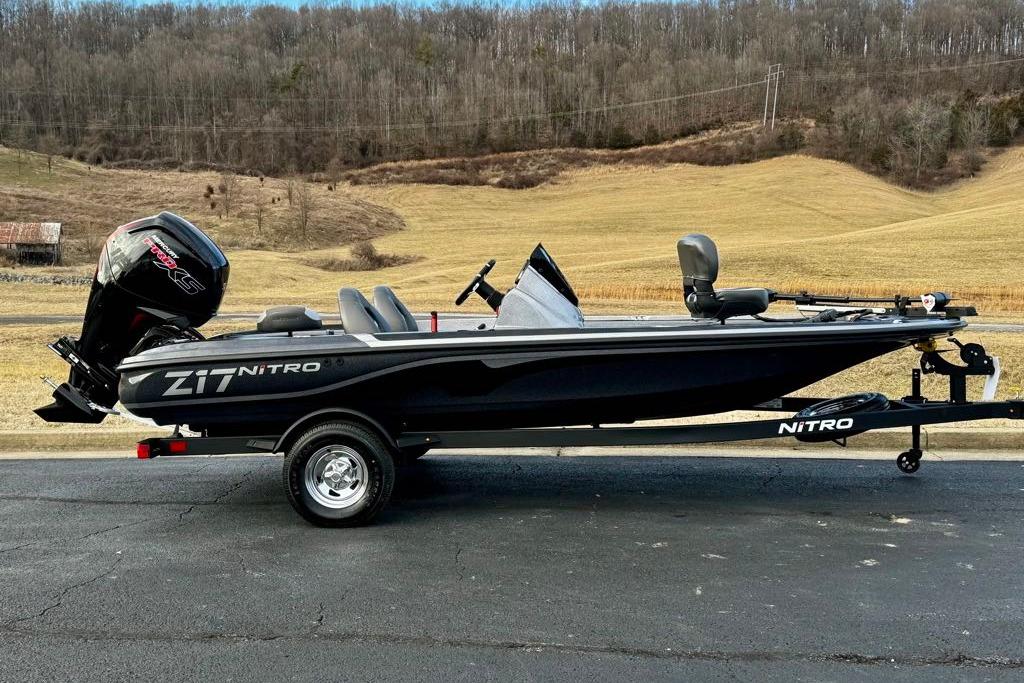 2026 Nitro Z17 boat on trailer, parked on road with scenic countryside background.