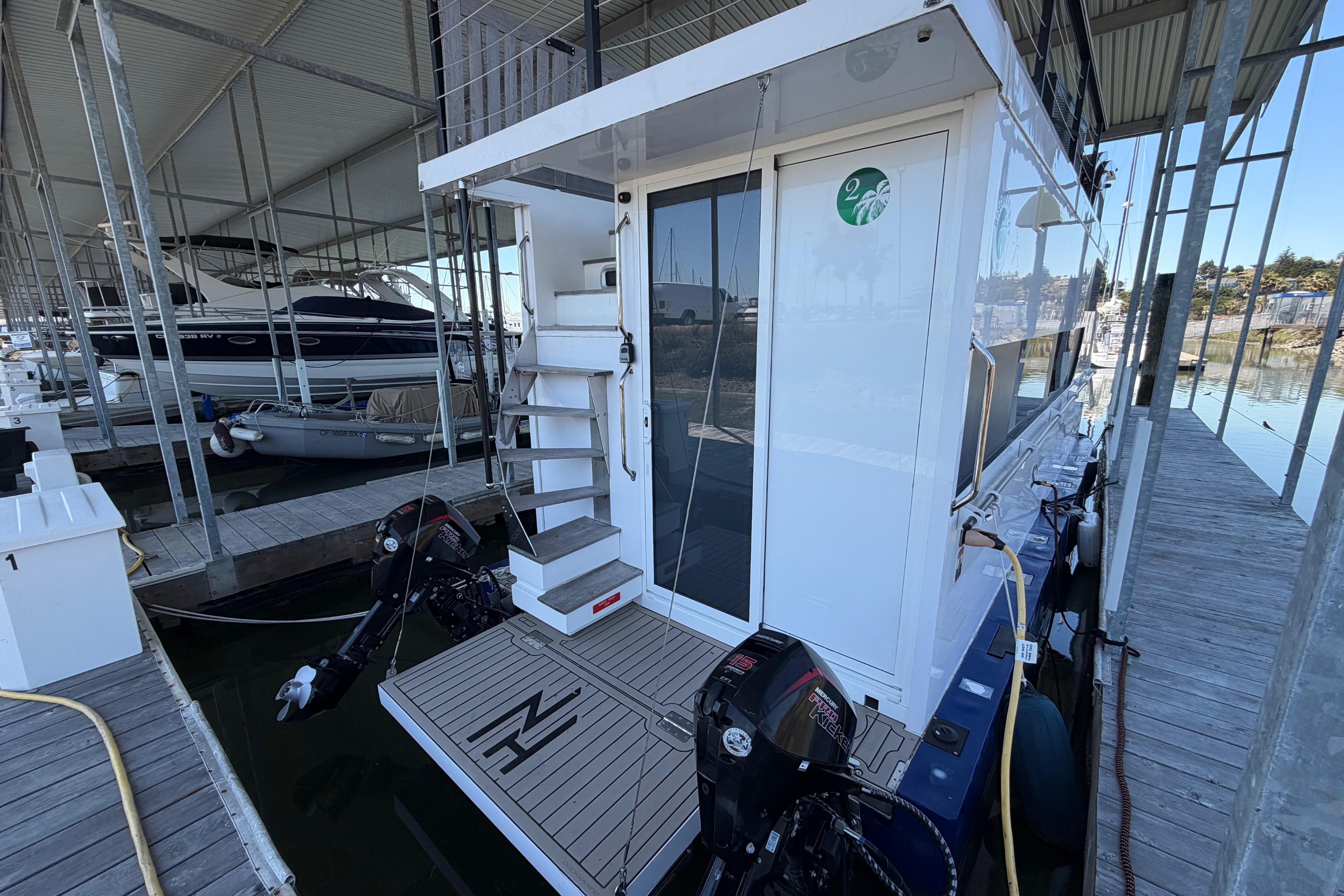 Navisyo NV.08 2022 model docked in a marina, showcasing modern design and twin outboard motors.