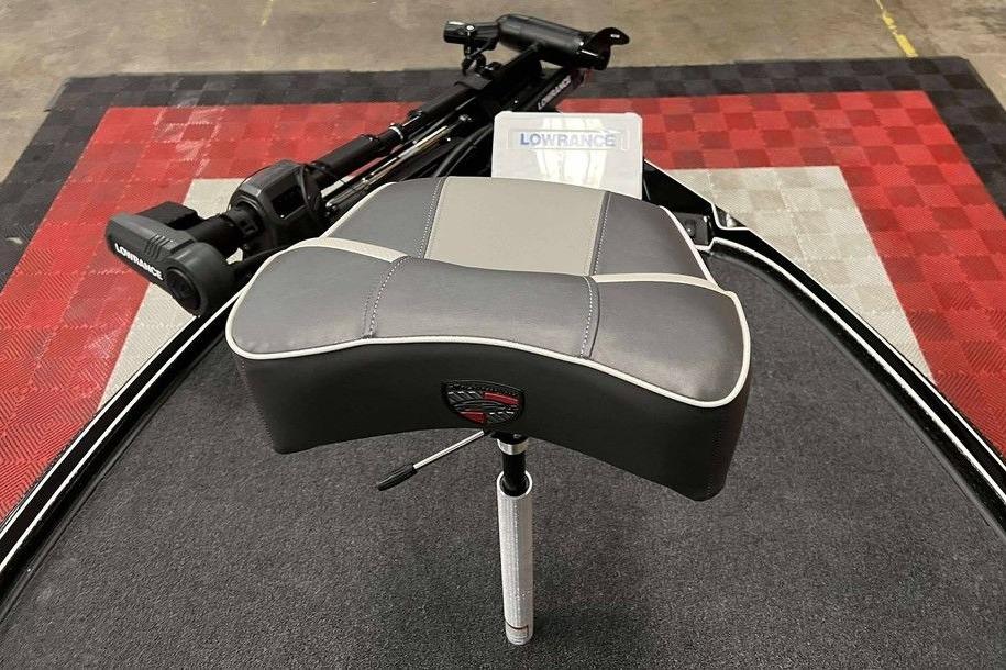 Triton 20XP Patriot 2026 boat seat with Lowrance equipment on red and black checkered floor.