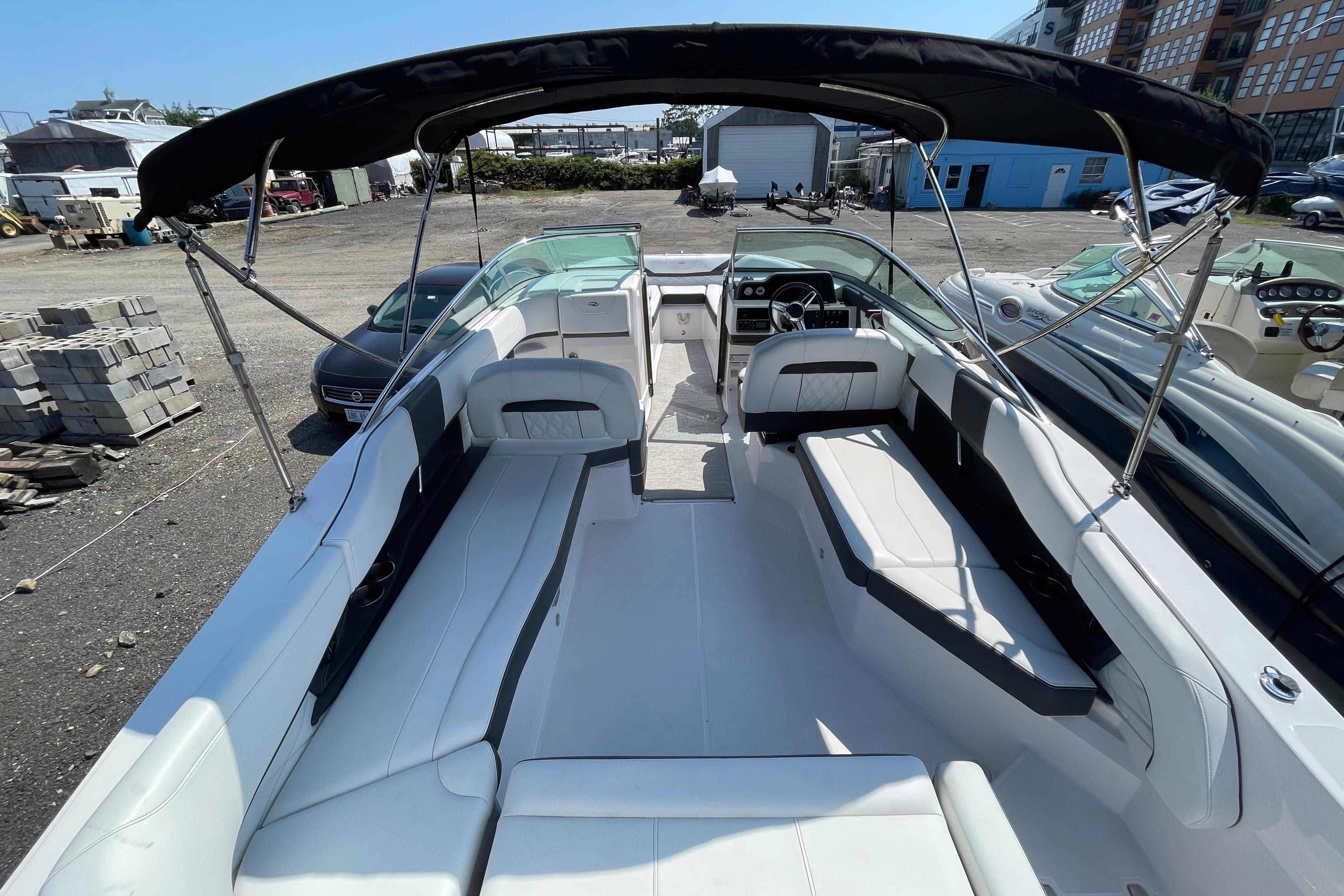 2018 Regal 26 OBX boat with spacious seating and canopy in a marina setting.