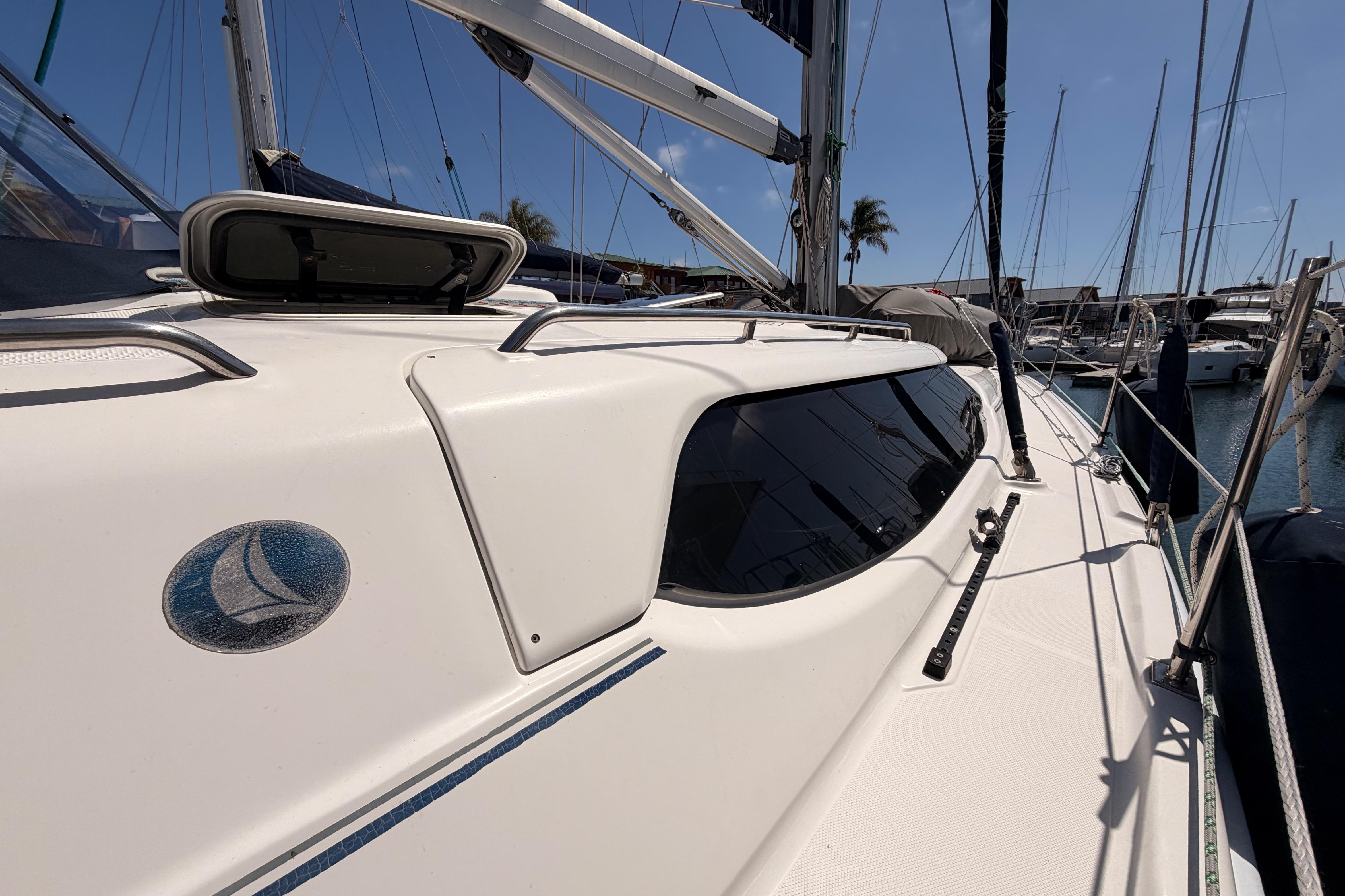 2008 Hunter 45 Deck Salon sailboat docked in marina, showcasing sleek design and windows.