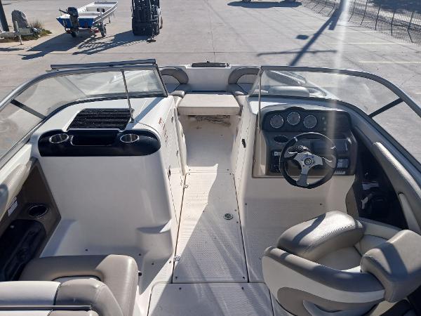 2010 Yamaha Boats 242 Limited interior with steering wheel and seating.