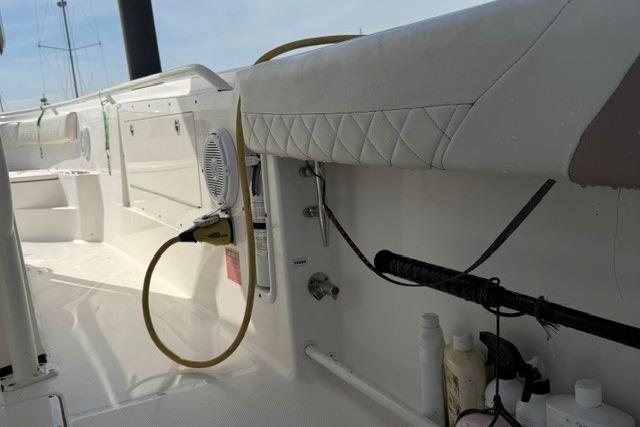 2014 Edgewater 318CC boat interior with seating, speaker, and fishing rod holder.