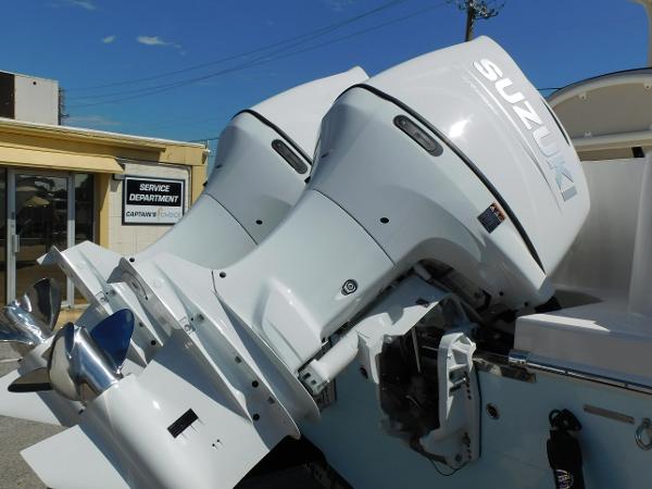 Twin Suzuki outboard motors on a 2024 Sailfish 242 CC boat.