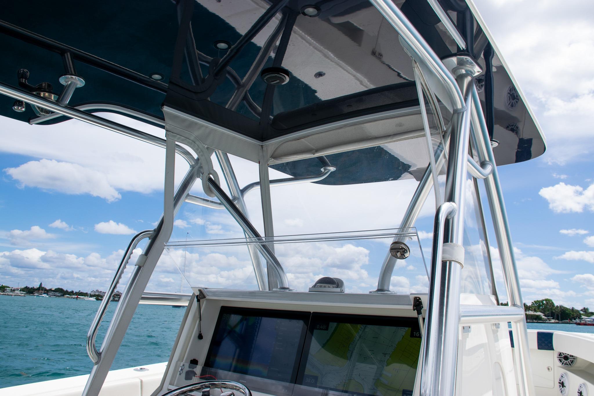 2022 SeaVee 390Z boat console with T-top against a blue sky and ocean backdrop.