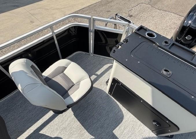 2026 Sun Tracker Fishin' Barge 20 DLX interior with seating and fishing station.