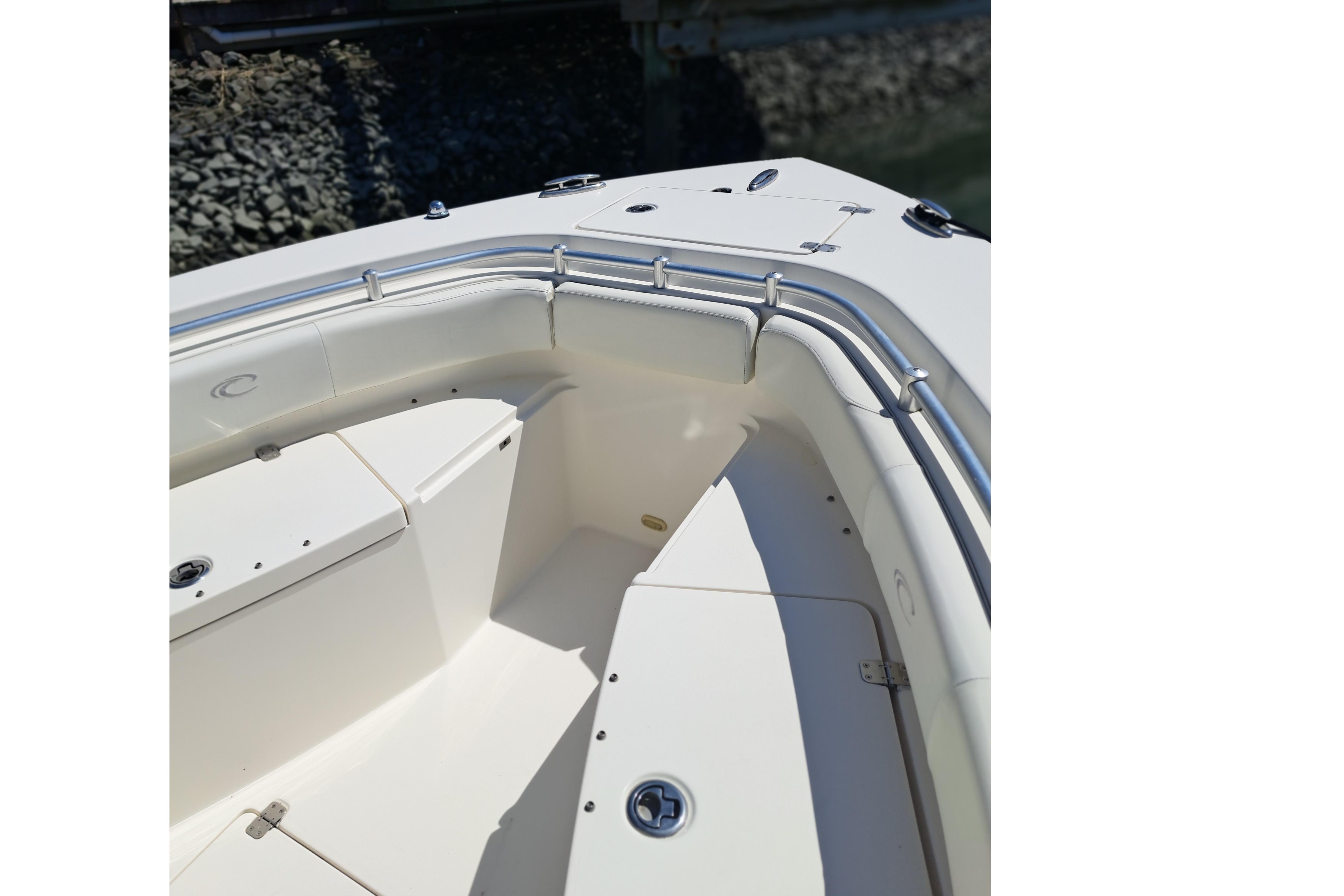 2014 Cobia 256 Center Console boat interior with cushioned seating and stainless steel railings.