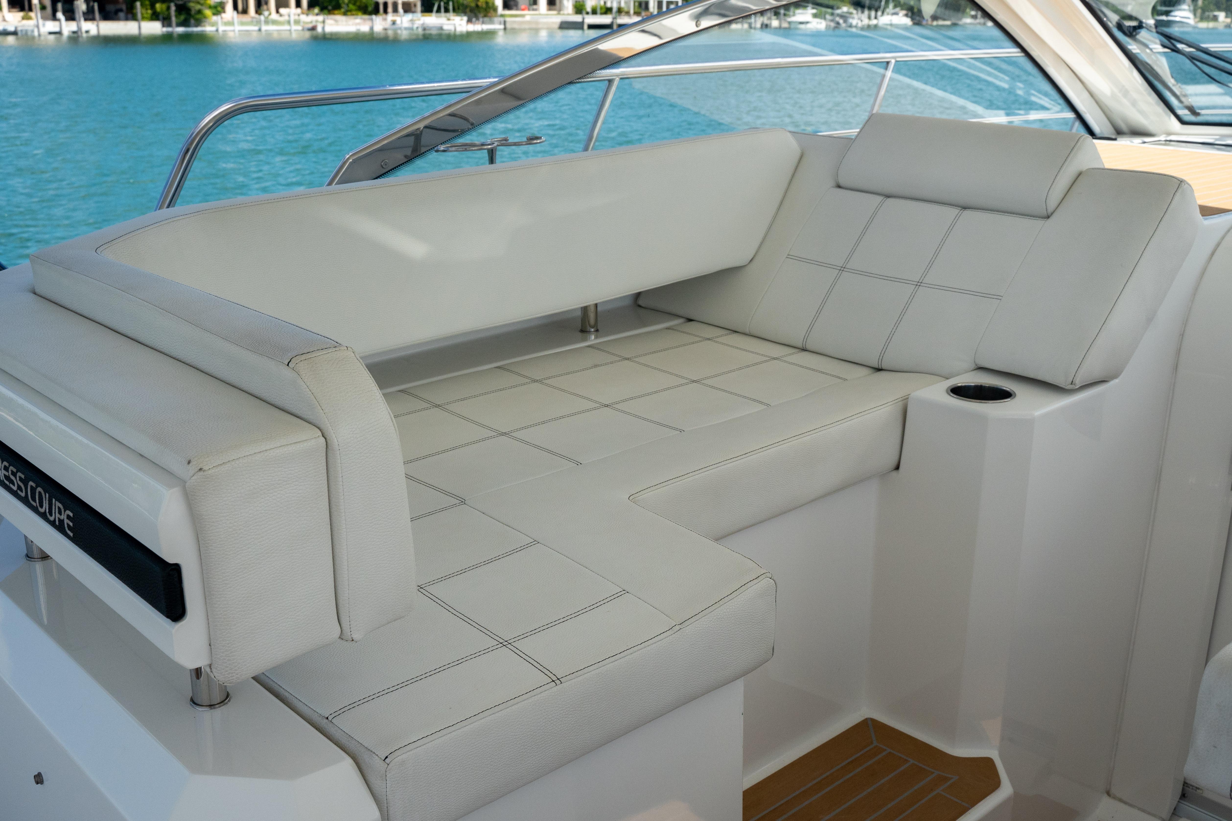 2018 Cruisers Yachts 390 Express Coupe interior with white seating and scenic water view.