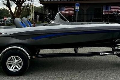 2026 Ranger Z185 boat on trailer, parked outdoors, with American flags in the background.