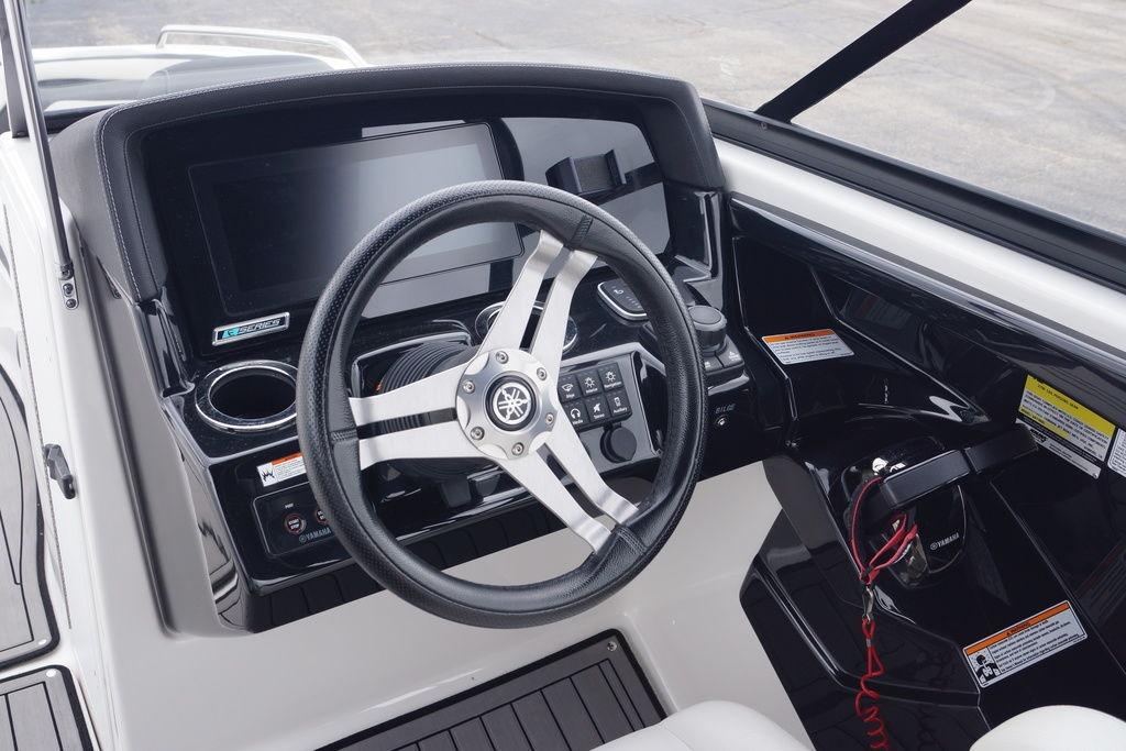 Steering console of 2018 Yamaha Boats 242 Limited S with modern controls and display.