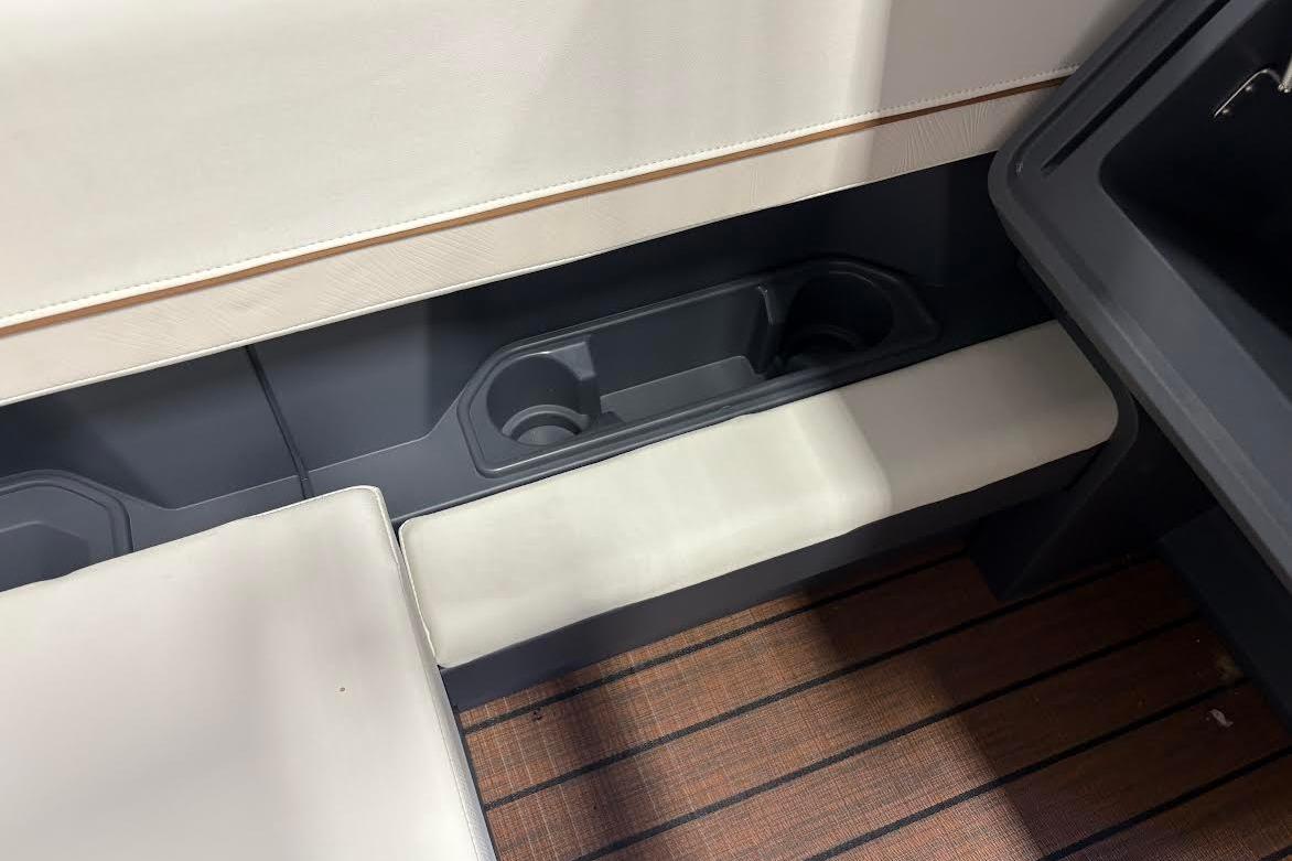 Interior seating and cup holders of 2023 Manitou EXPLORE 26 SHP 575 boat.