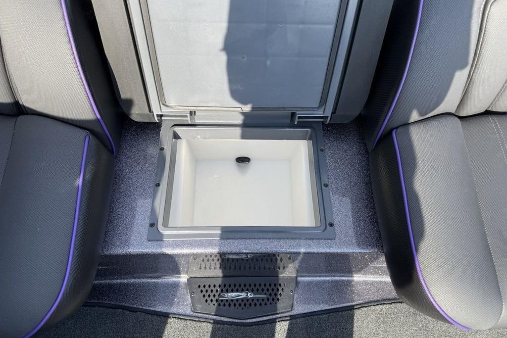 2026 Skeeter ZXE20 boat interior with open storage compartment between seats.