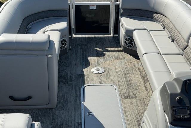 2025 Ranger Reata 223C pontoon boat interior with gray seating and wood-style flooring.